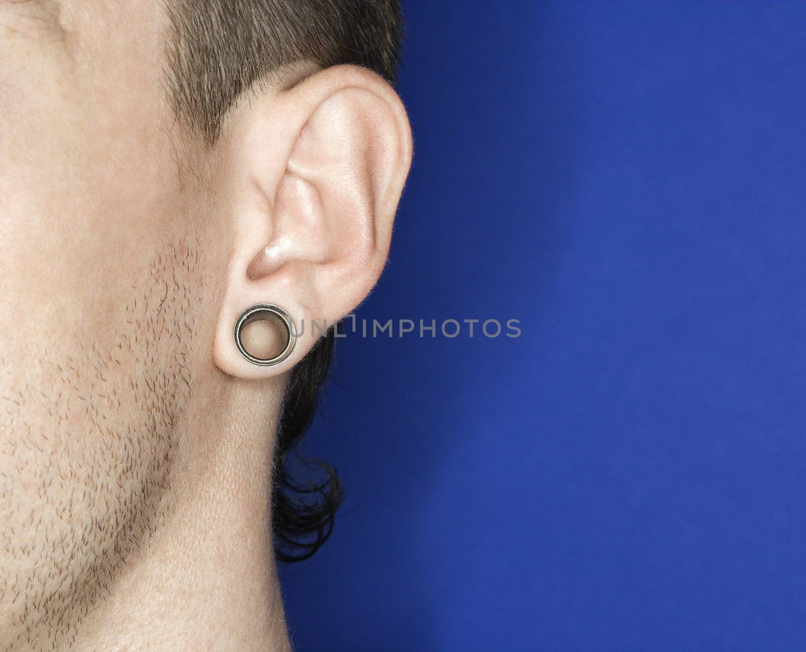 Young adult Caucasian male pierced ear.