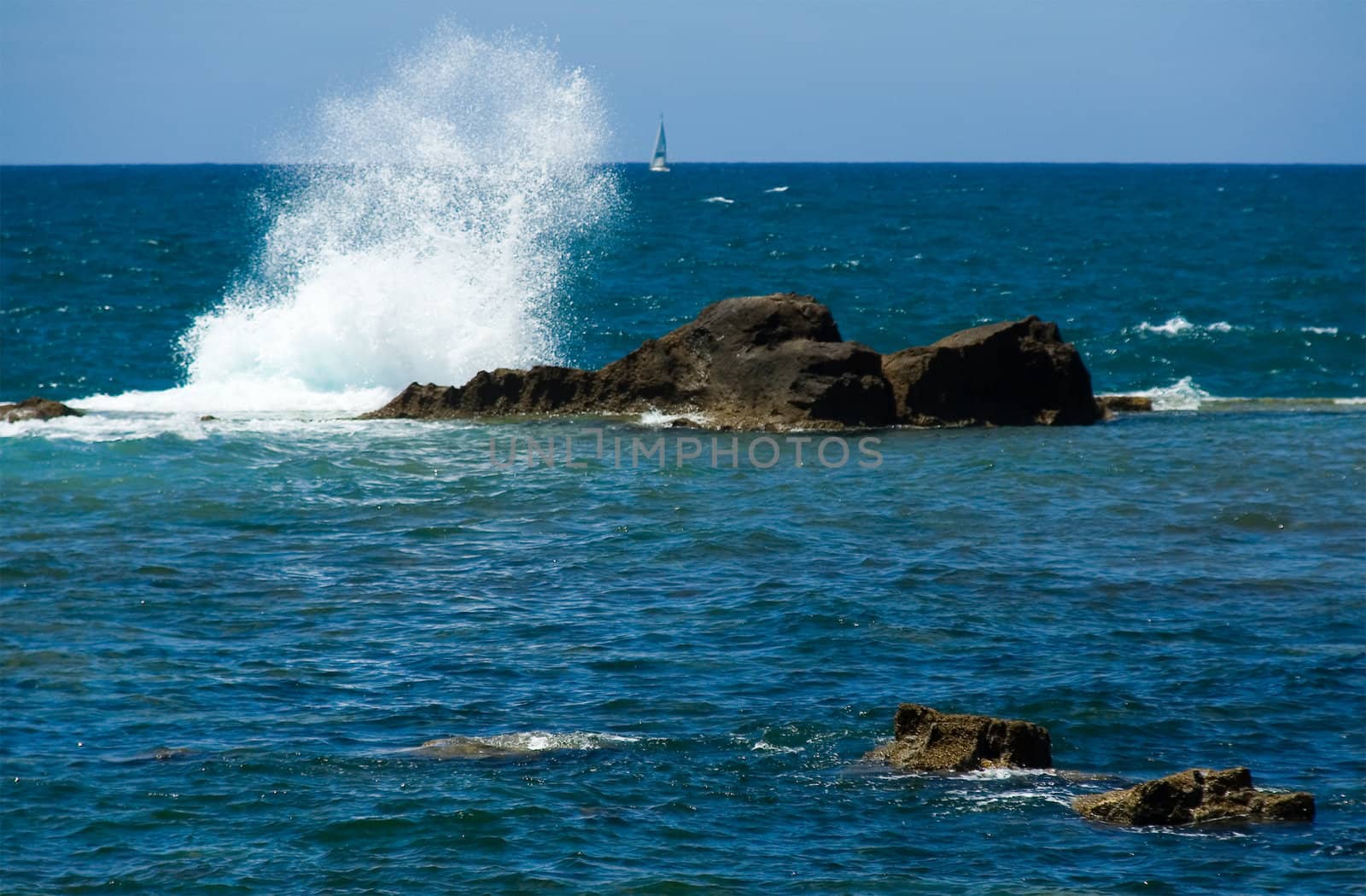 Surf of Mediterranean sea and sailing vessel on a background