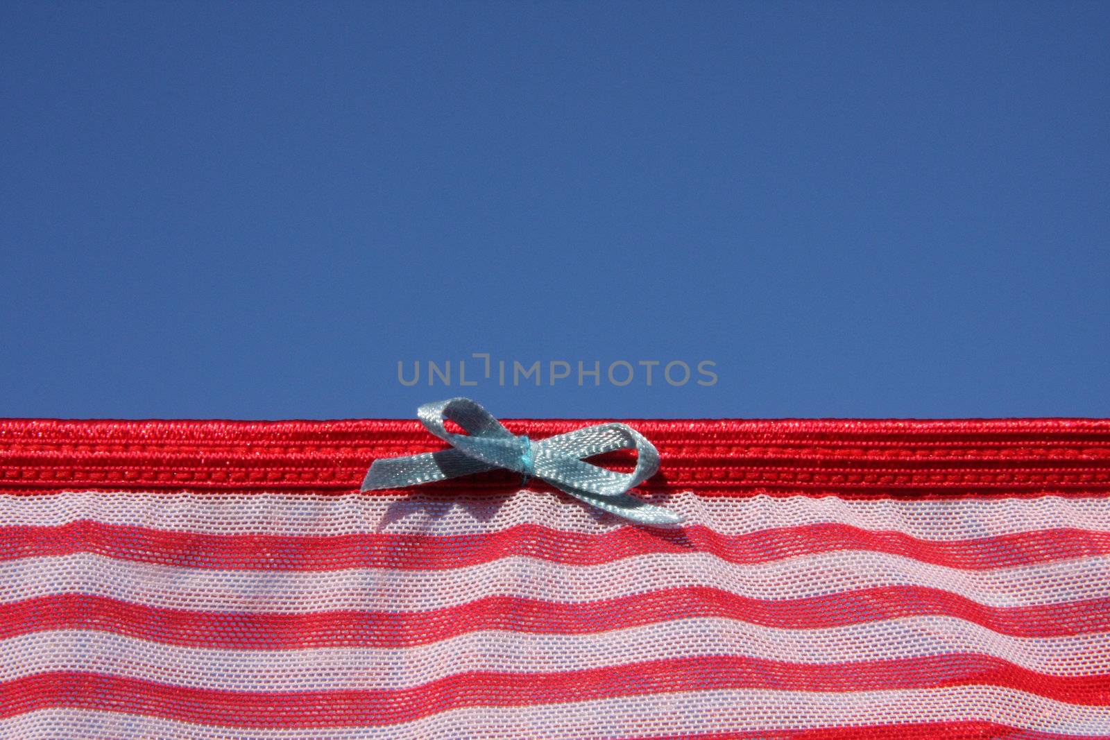 Clothes on washing laundry line, red lingerie, blue sky