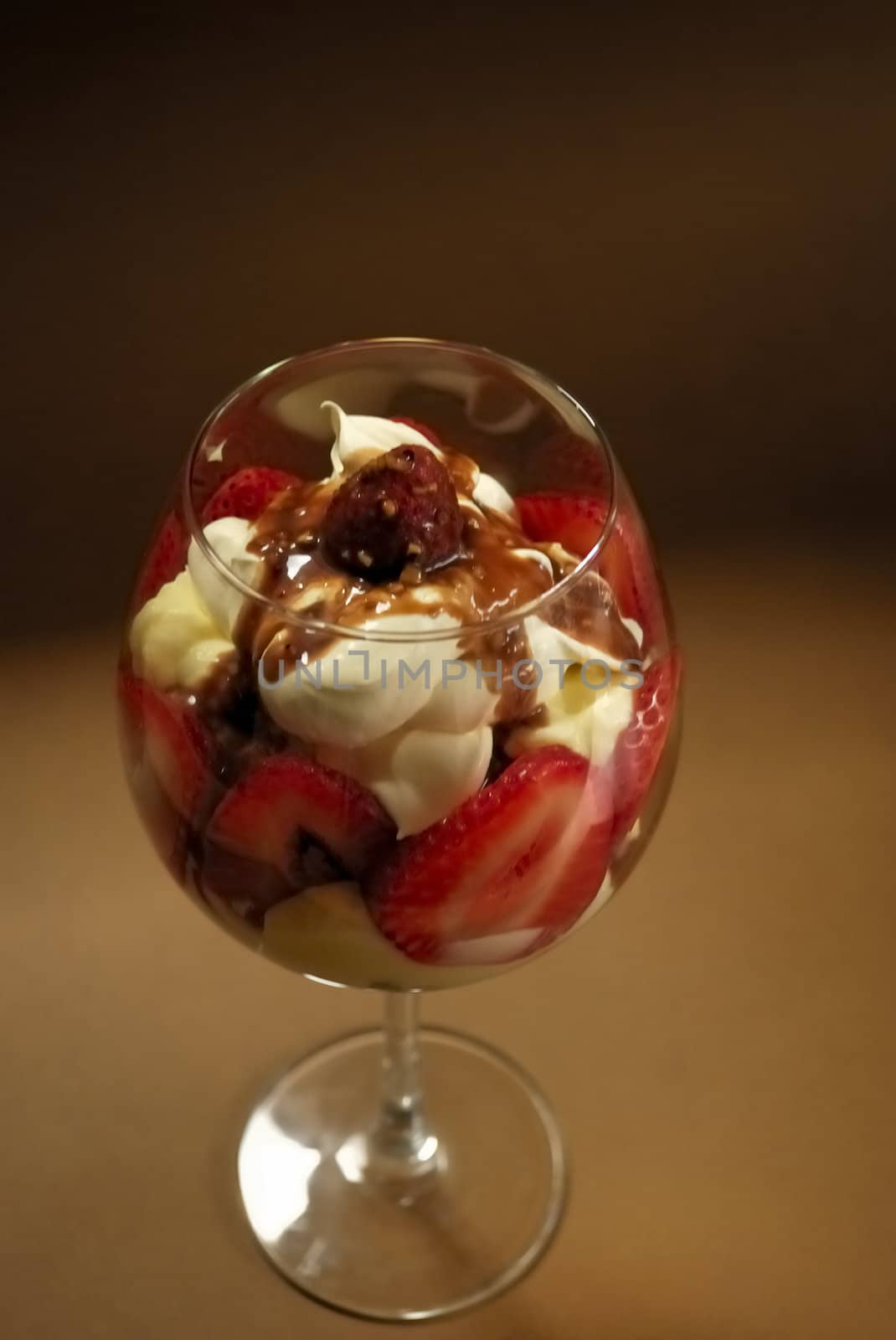 Straberry trifle in large wine glass.
