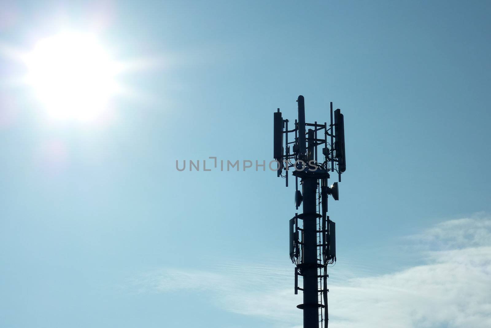 Silhouette of transmitter tower showing sunflare