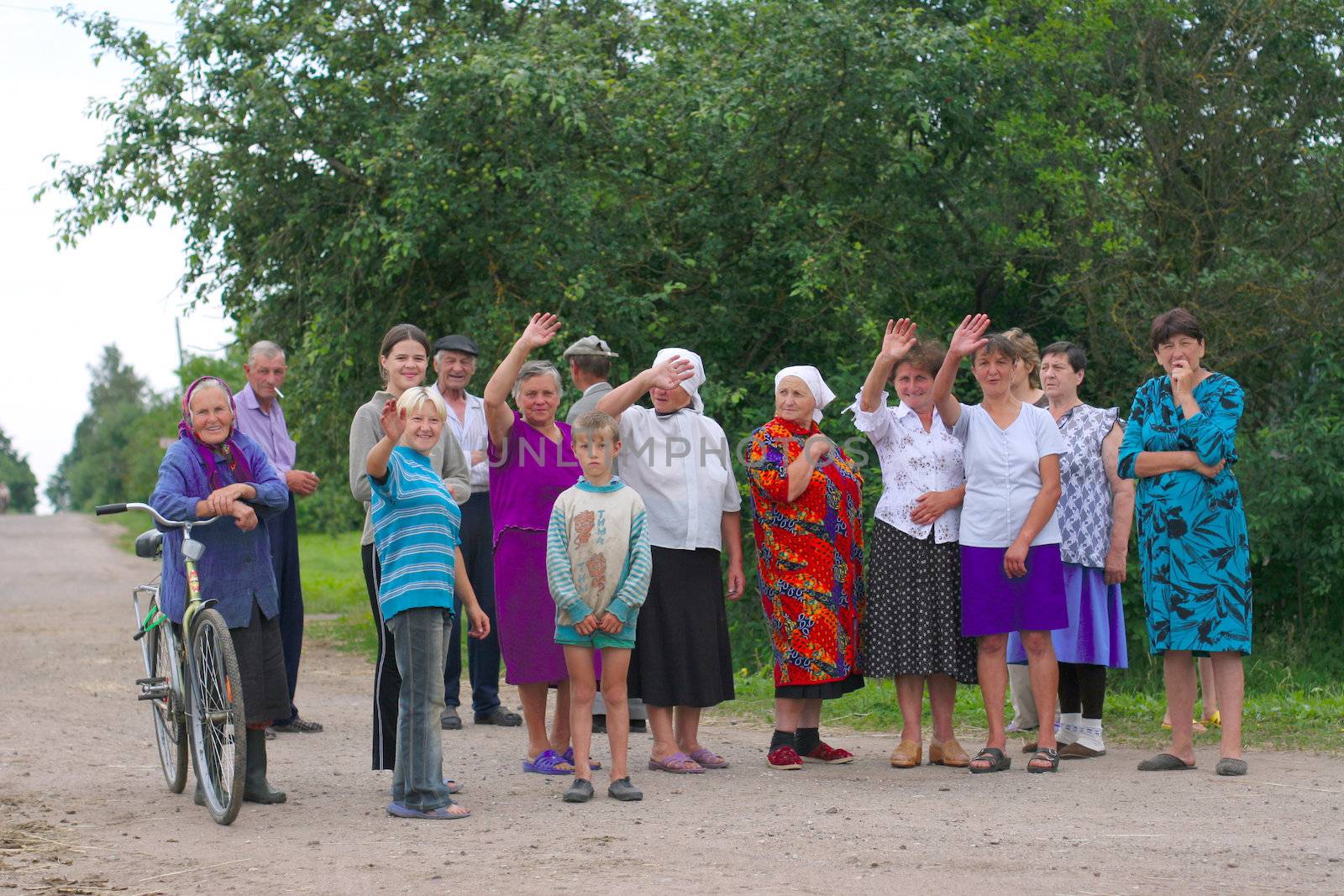 group of village farmers welcomes piligrims from Roman Catholic church by the road in Miory, Belarus