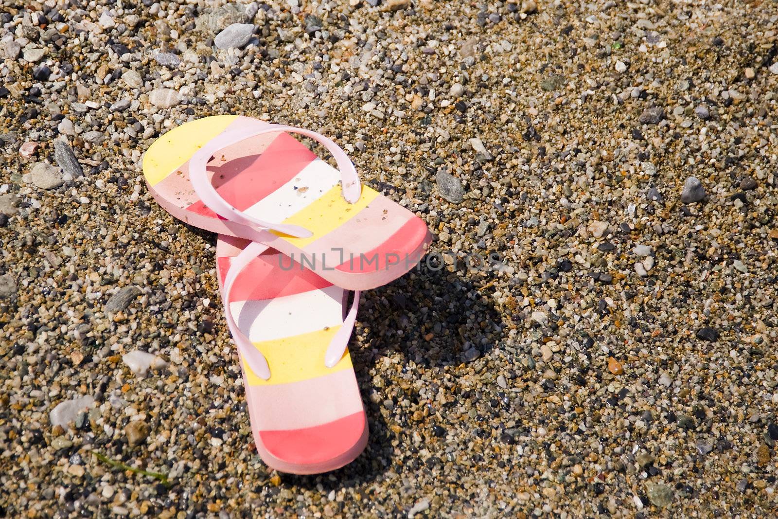 two colorful slippers on the beach