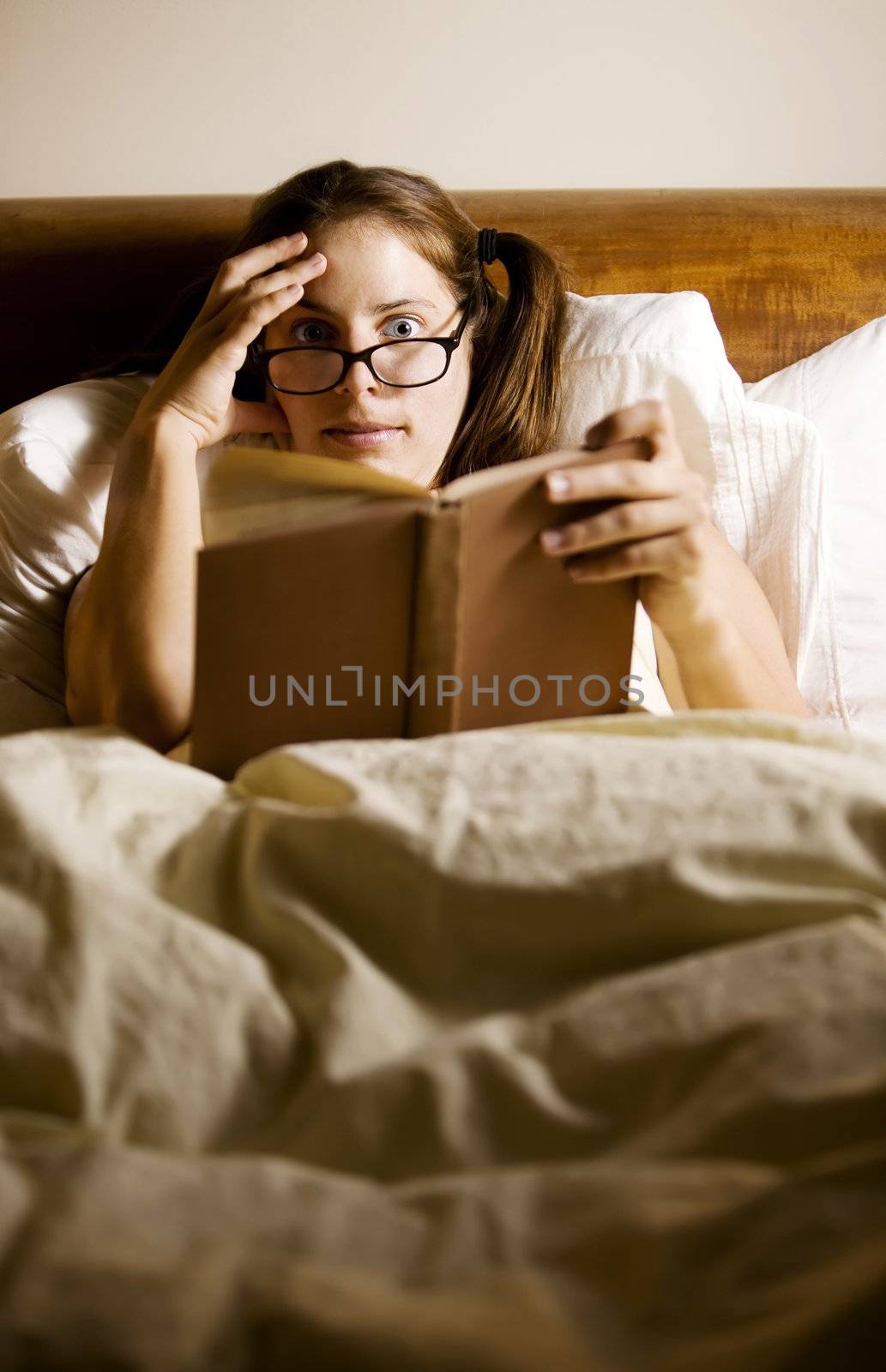 Woman Reading in Bed by Creatista
