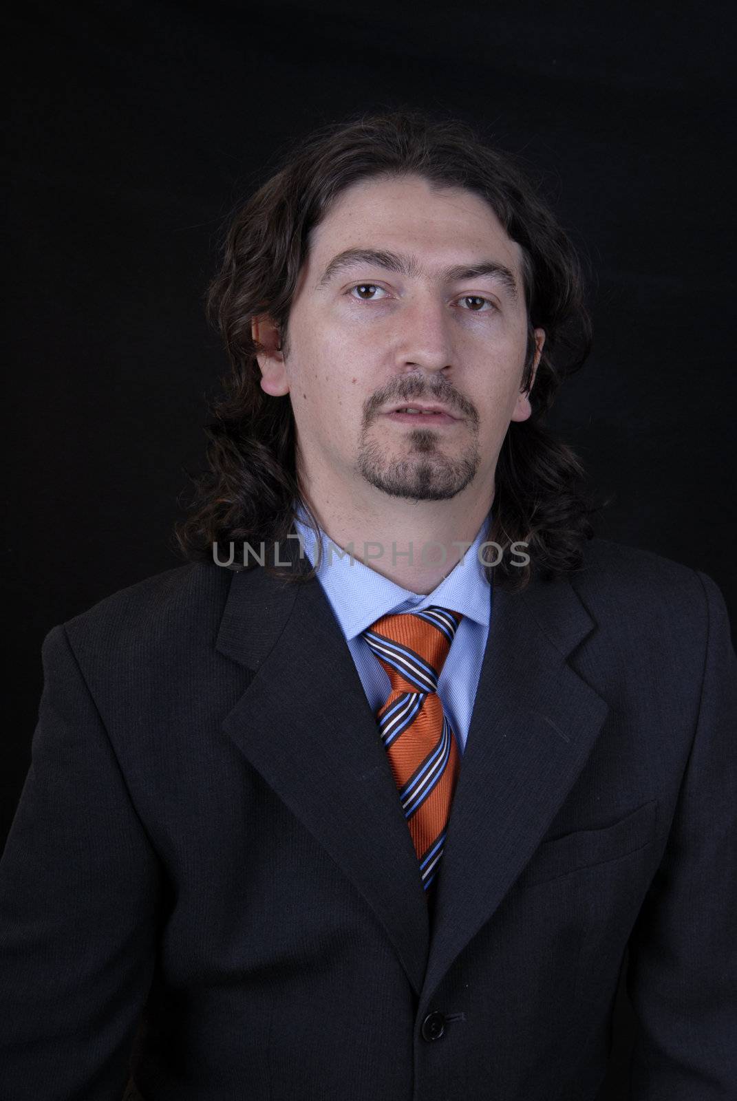 young business man portrait on black background