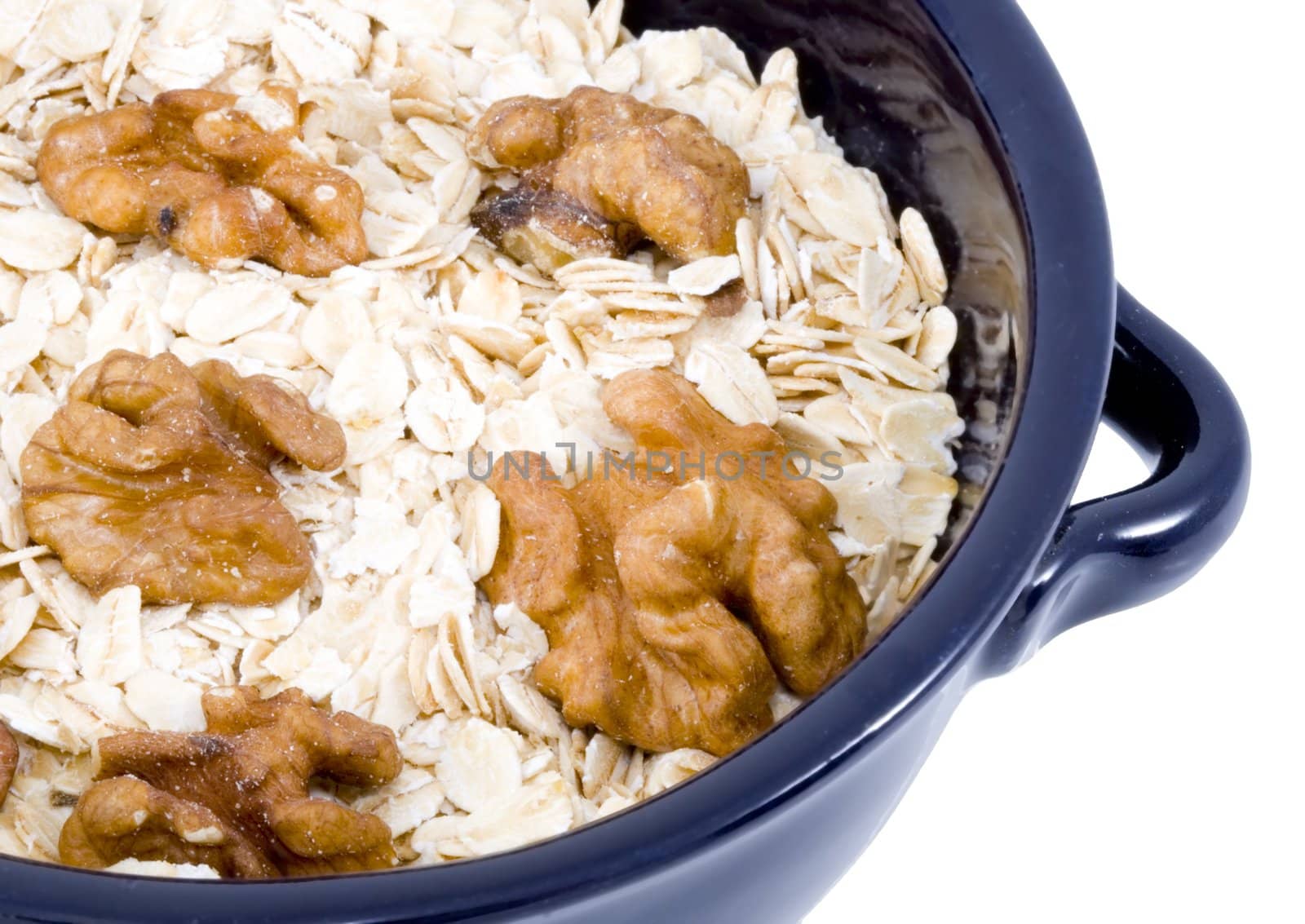 a bowl of oatmeal with walnuts - healthy diet