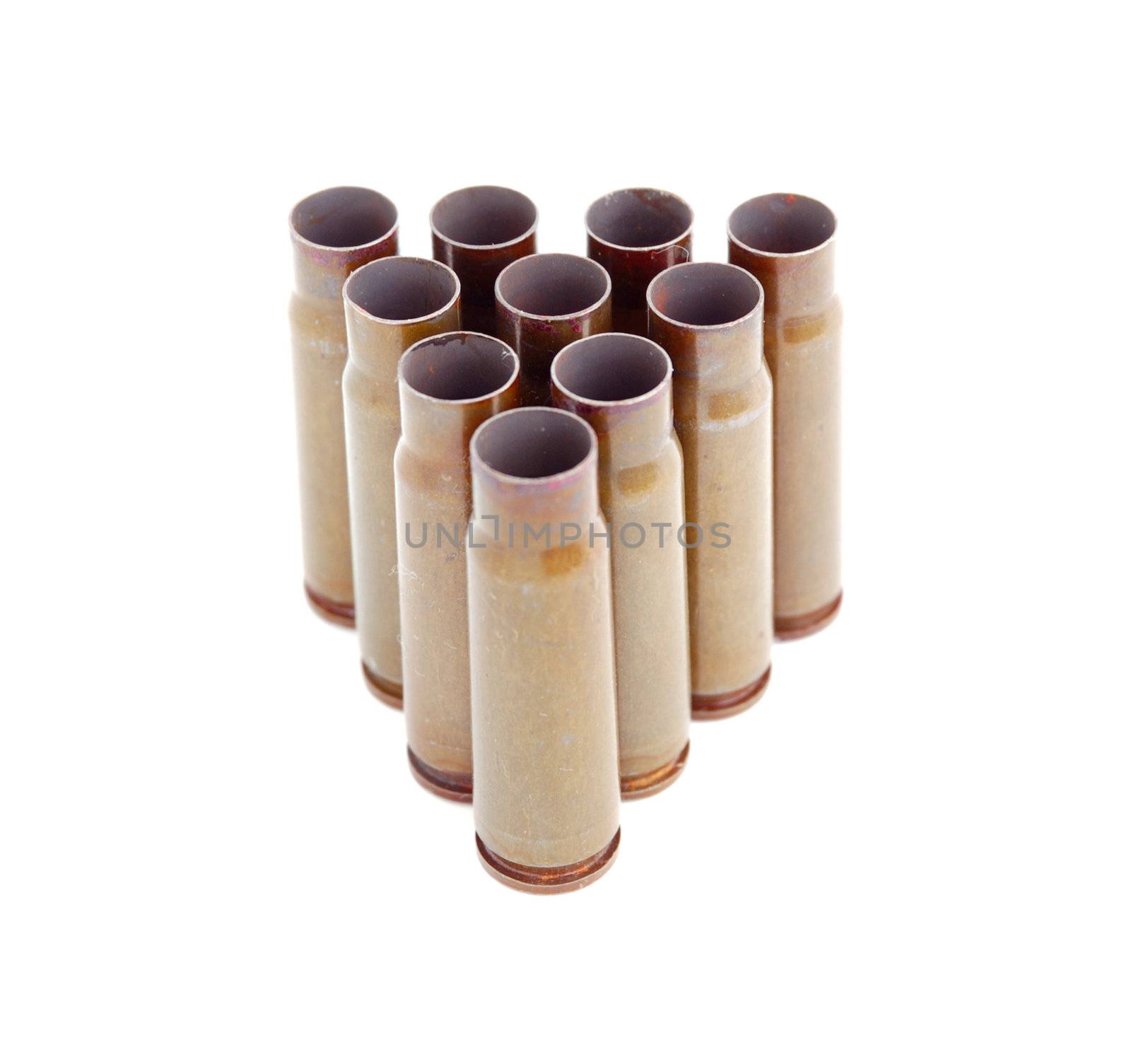 closeup of triangle of old used 7,62 mm shells (cartriges) of AK47 isolated on white