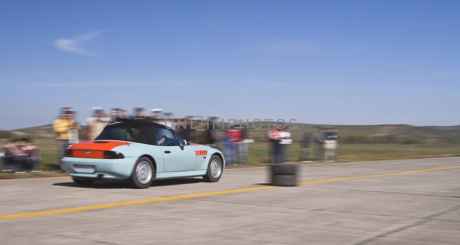 Panning image of a trendy car during a legal street car race.
