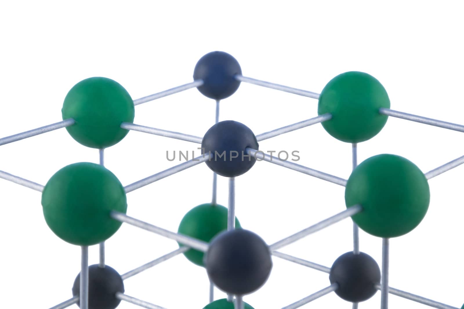 Image of a network of atoms, part of a NaCl molecule, isolated against a white background.