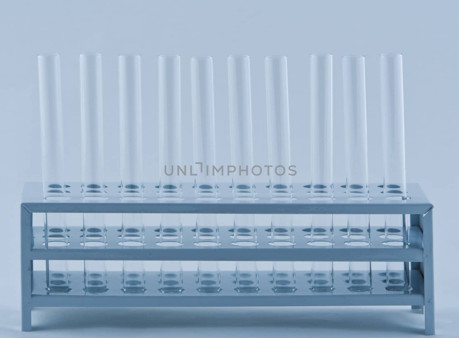 Empty laboratory tubes in a support.