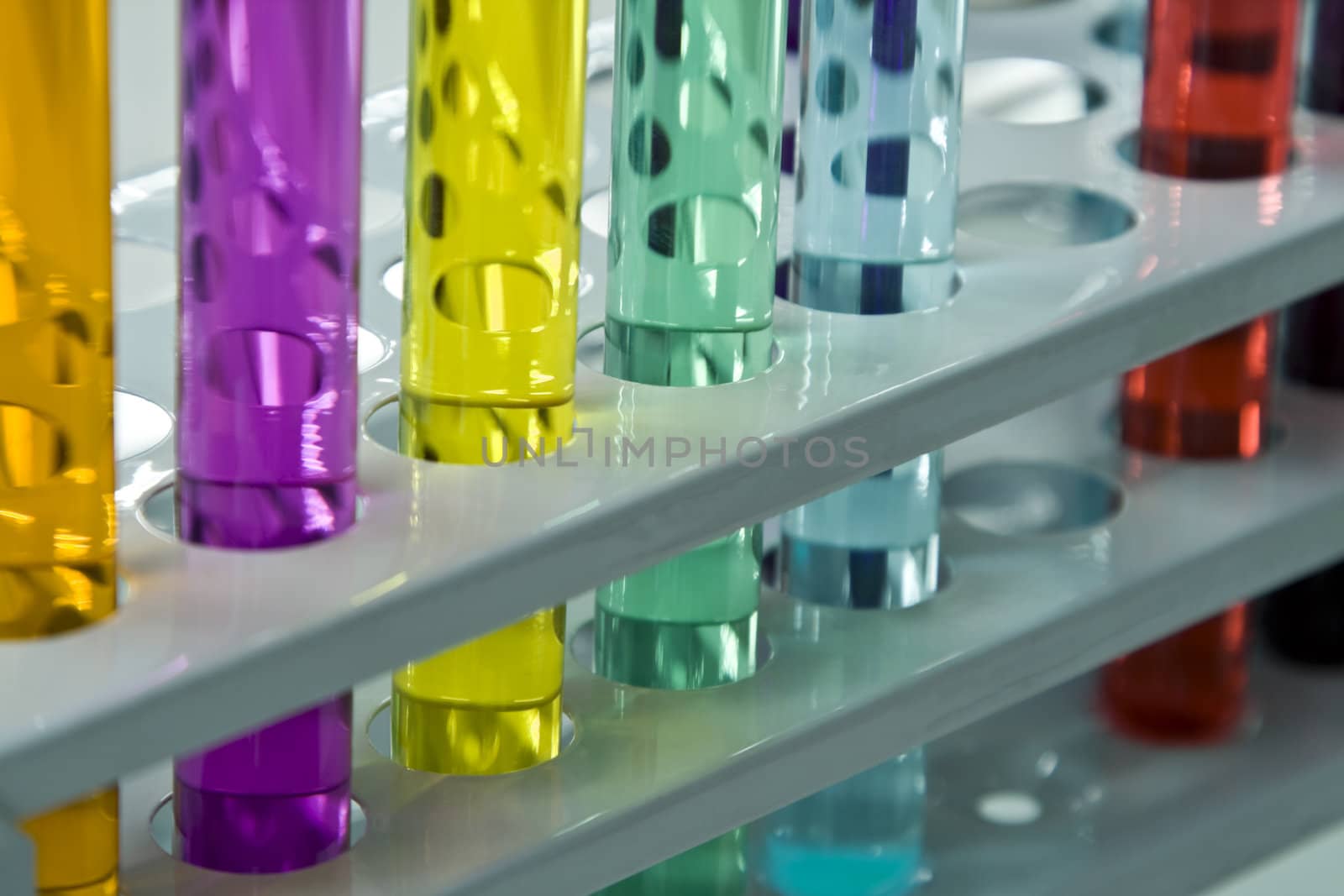 Colorful image and interesting reflections on a test tubes stand; unmodified specific lighting for a laboratory.