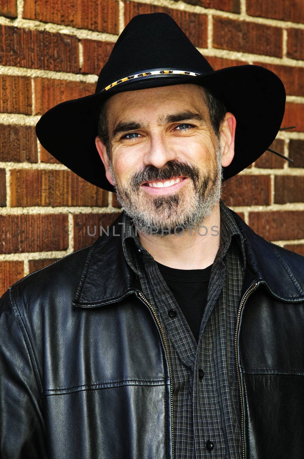 Man with beard in cowboy hat and leather jacket