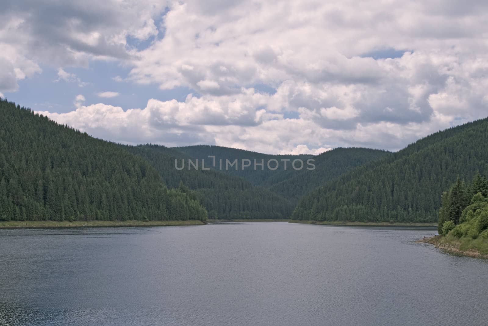 Beautiful cloudscape above the lake.Location:Fantanele Belis,Transylvania,Romania.