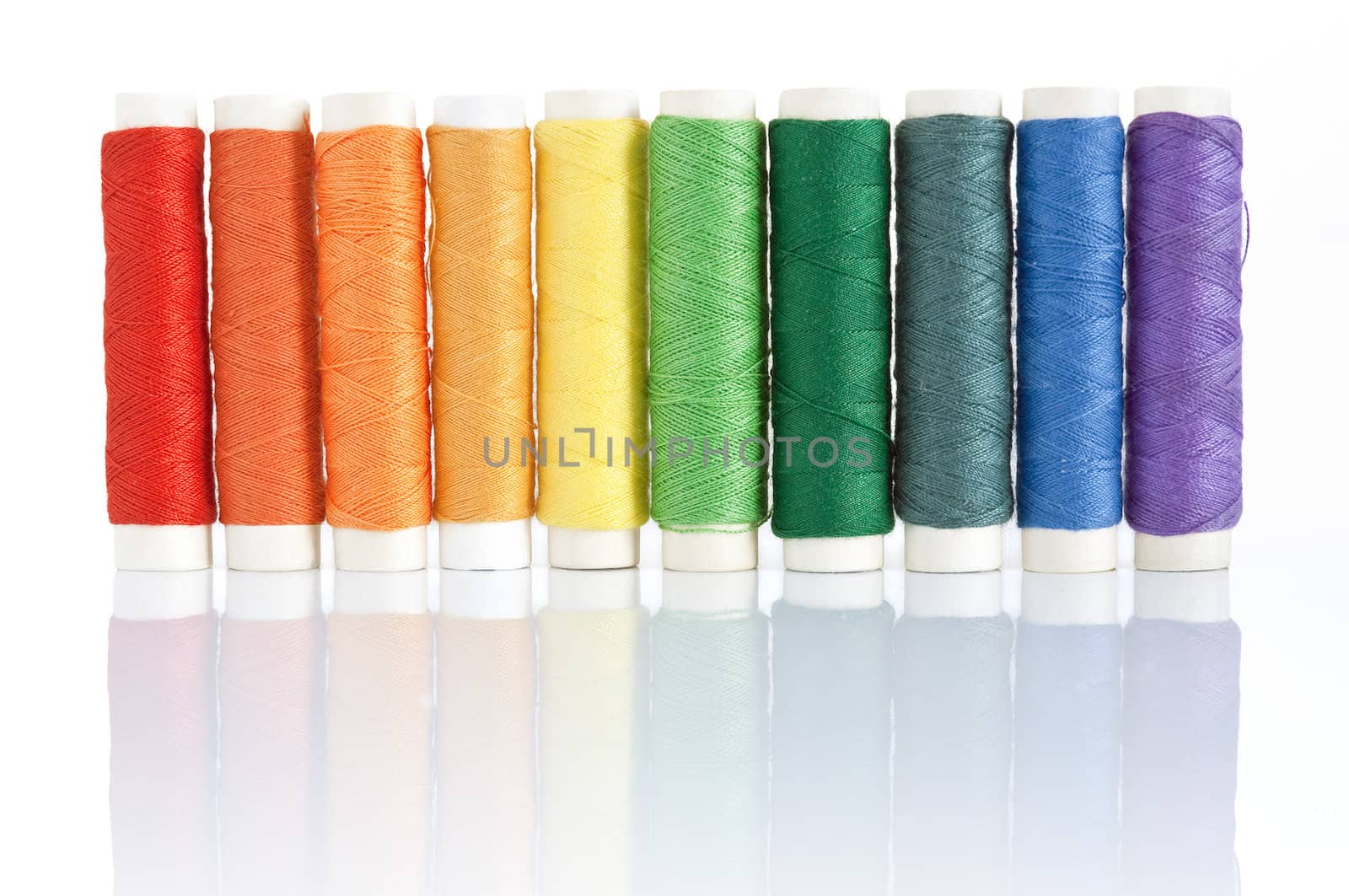 rainbow color spools threads isolated on white background