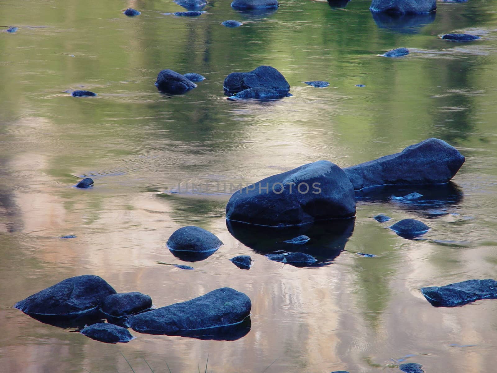 Blue rocks sitting in a mountain stream