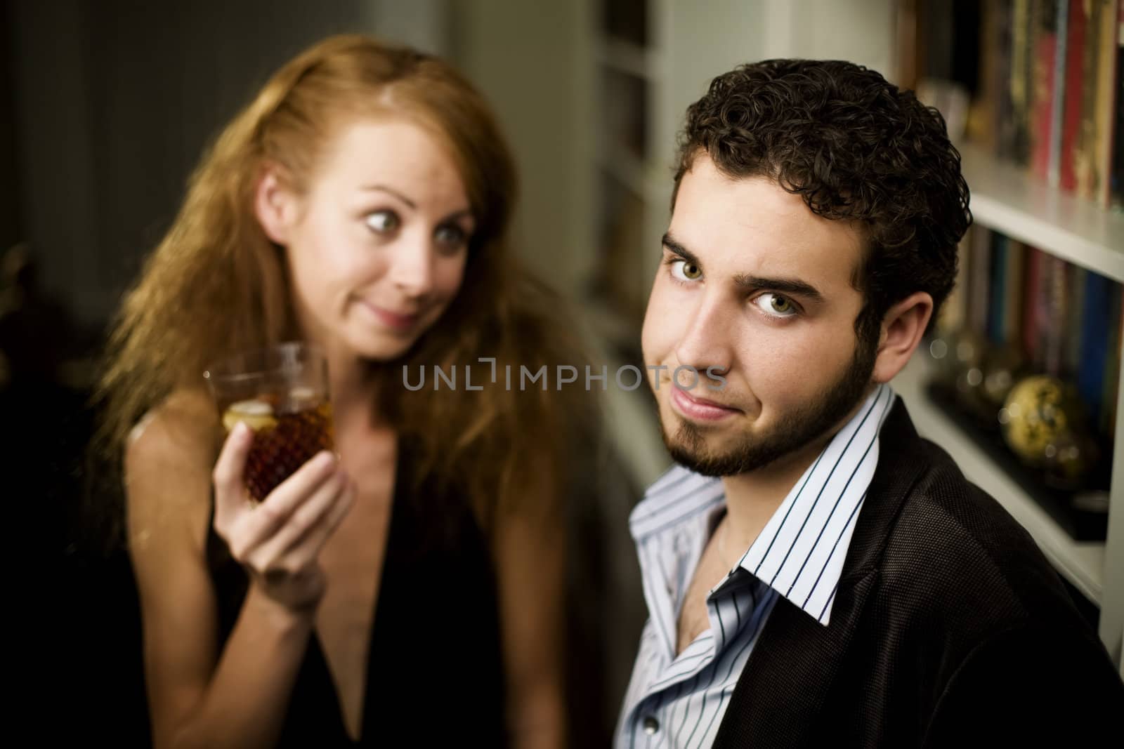 Young woman with big hair looks lovingly at young man