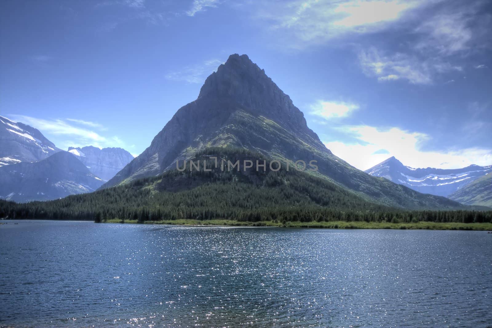 A glacier carved mountain rises above a lake.