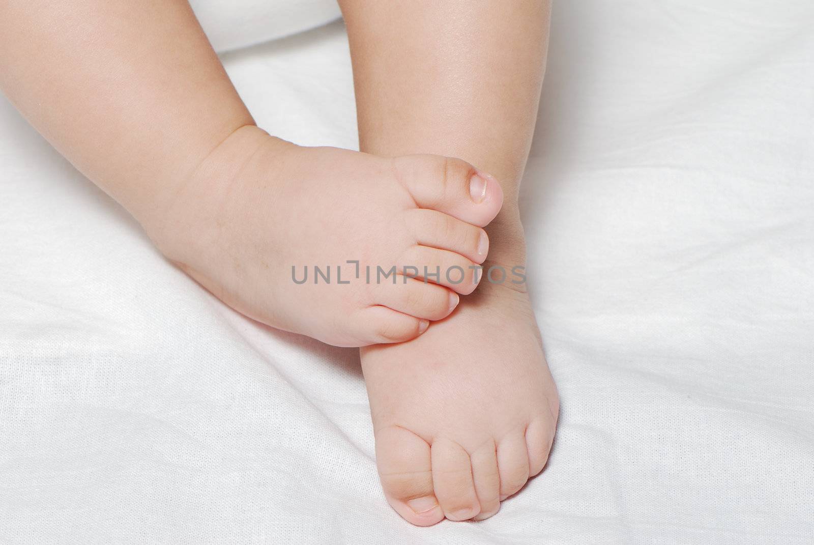 Legs of the baby on a light background