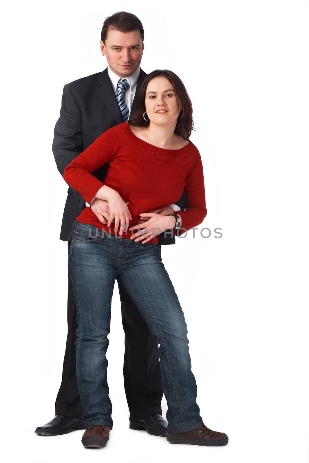  Portrait of an attractive young couple embracing against white background