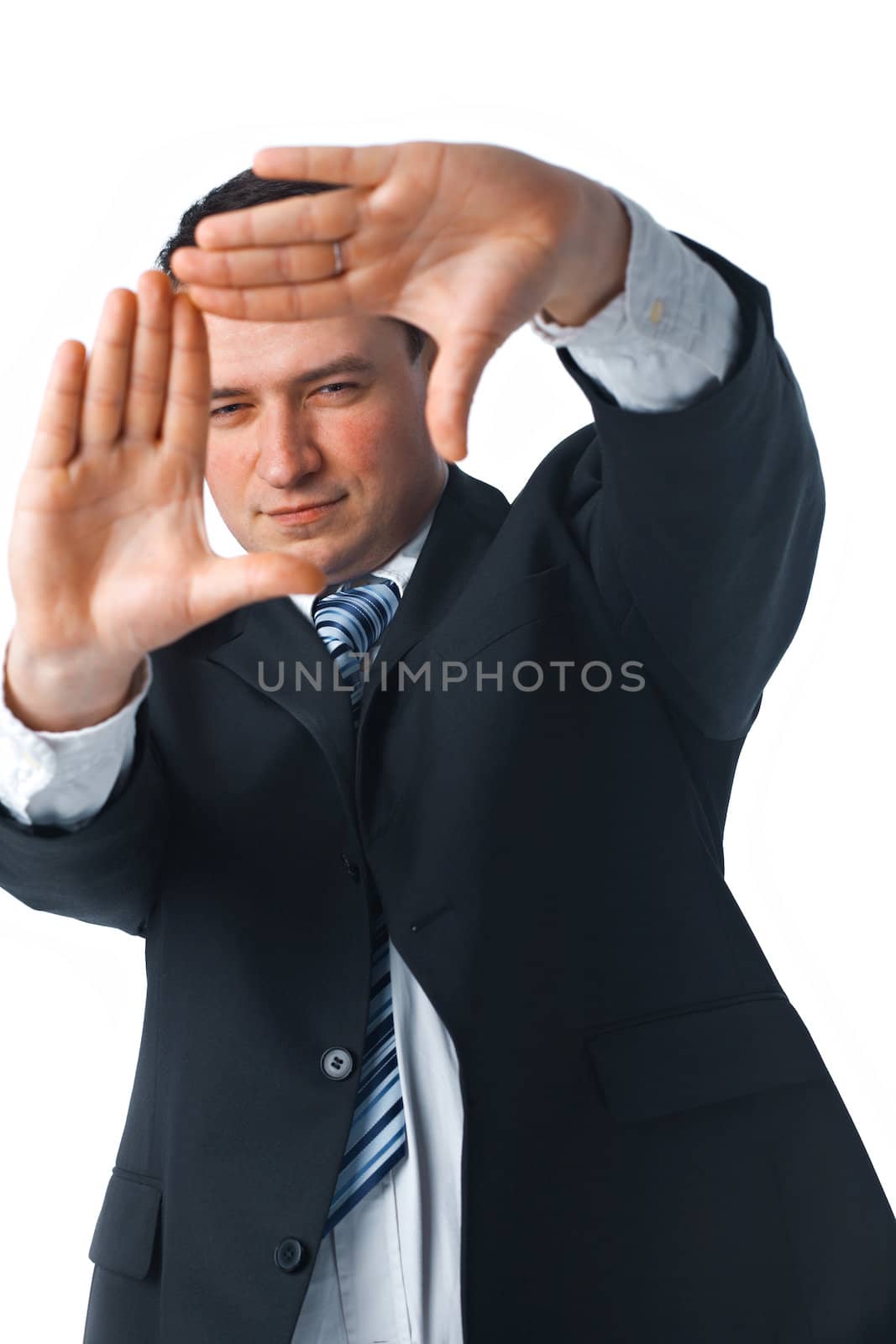 Portrait of a confident young businessman making a frame shape with his hands over white background 