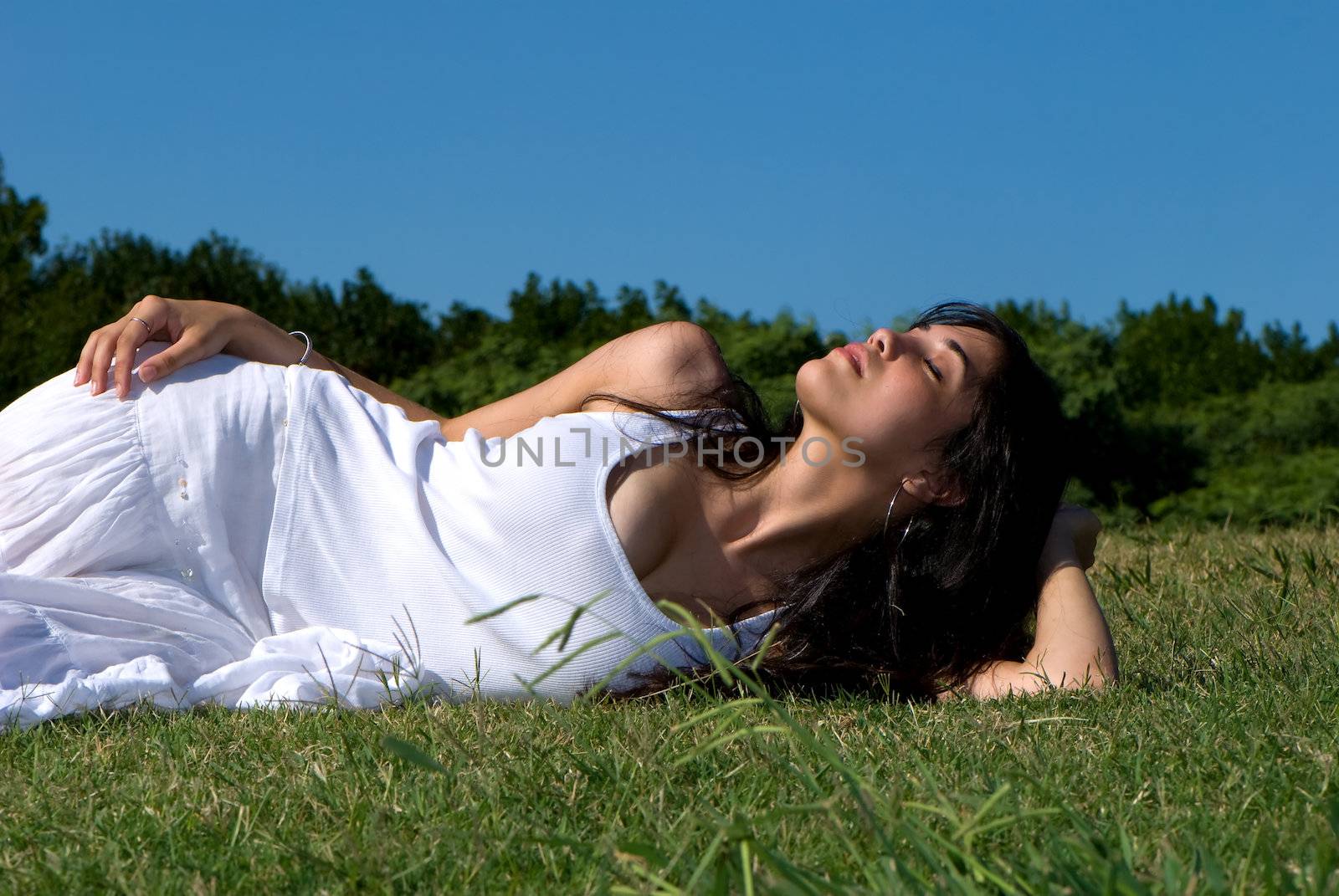 Relaxing girl on meadow