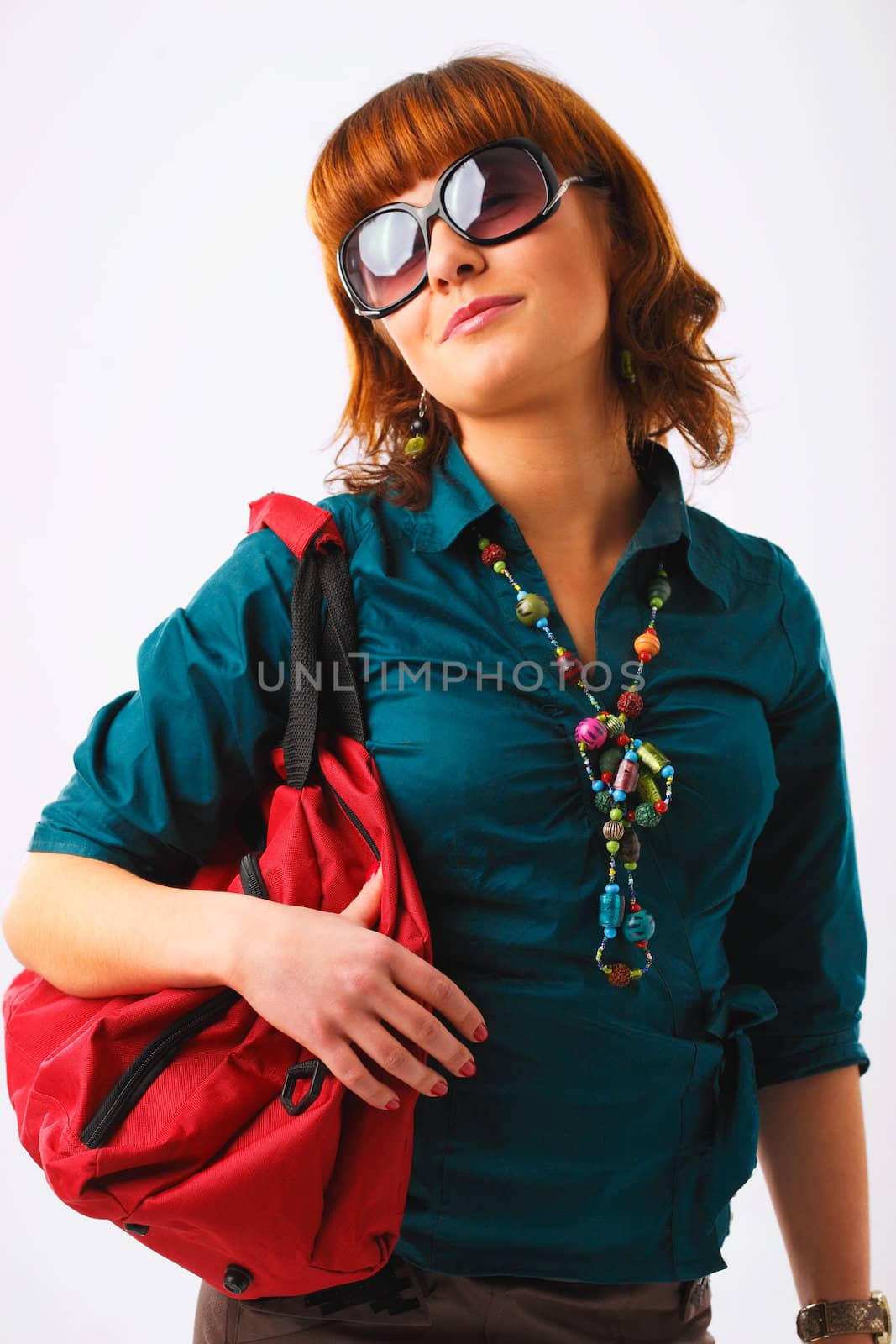 Beautiful young woman in sunglasses with her shopping bags