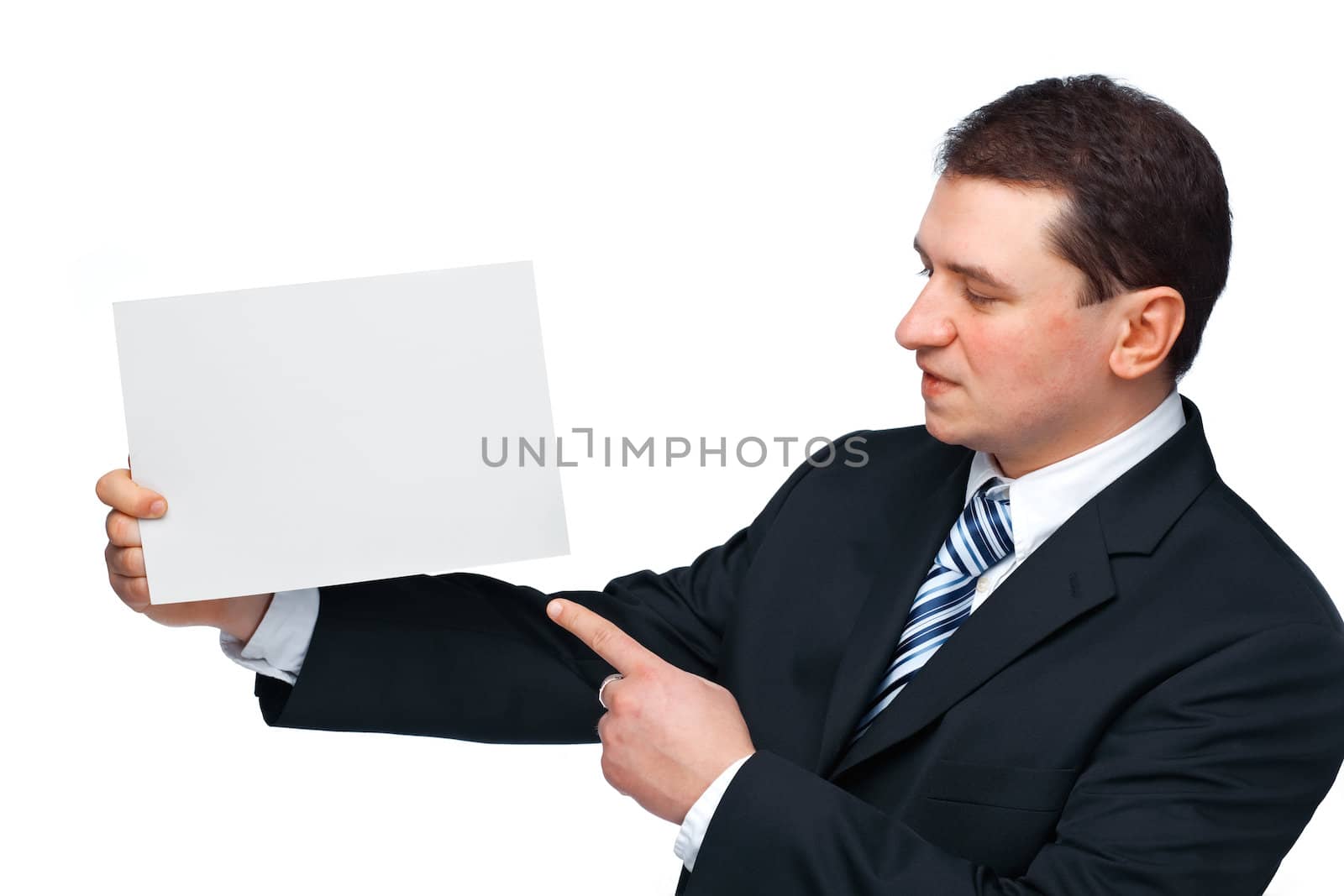 A successful happy business executive holding and pointing at an empty billboard 