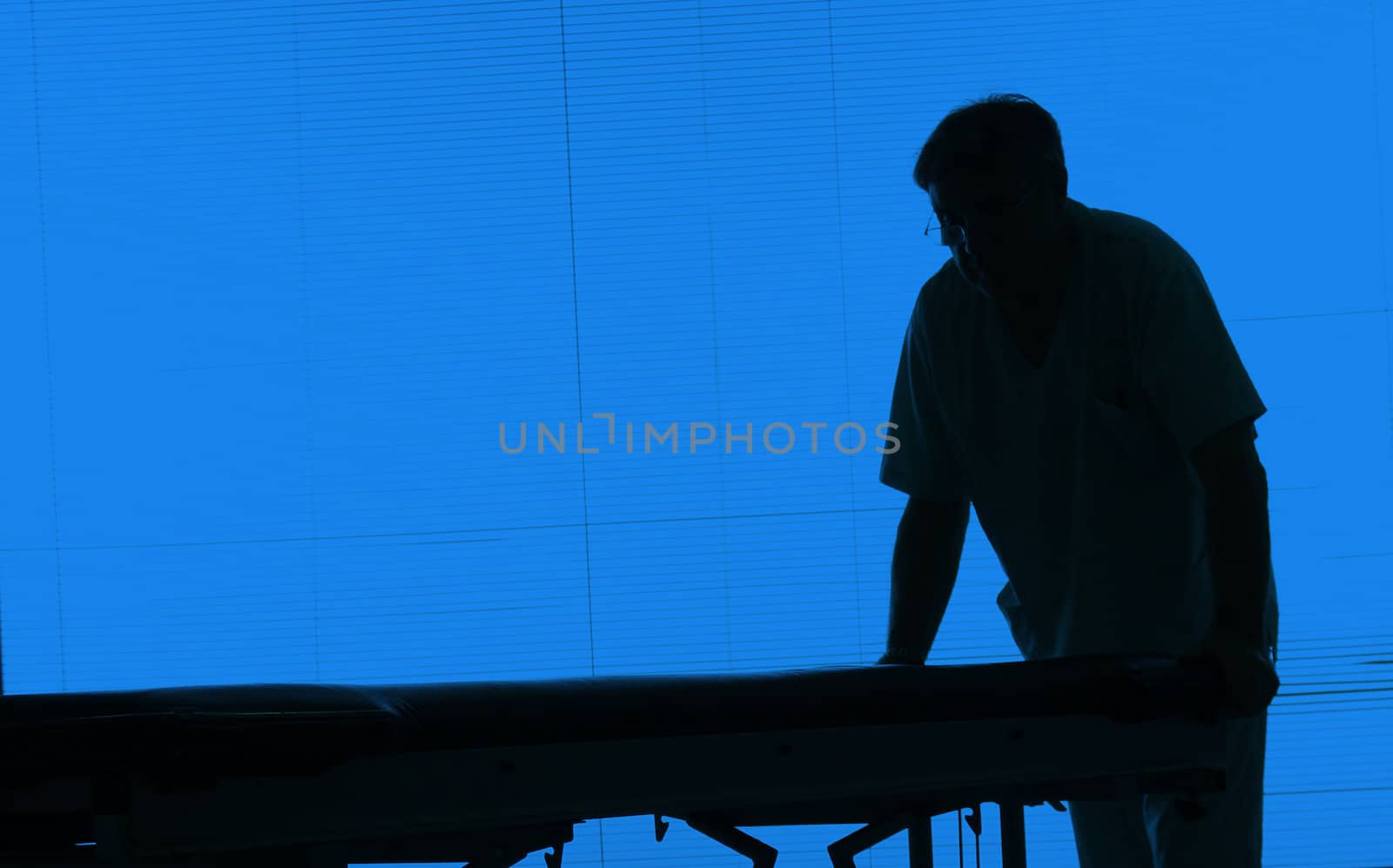 Doctor silhouette with an hospital bed at a hospital