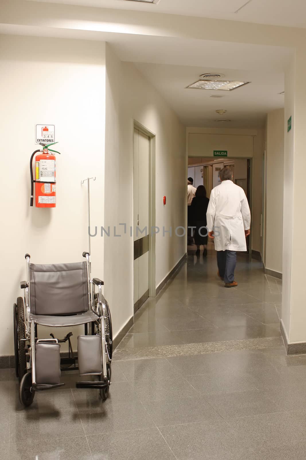 Doctor walking at the hospital hall by Erdosain