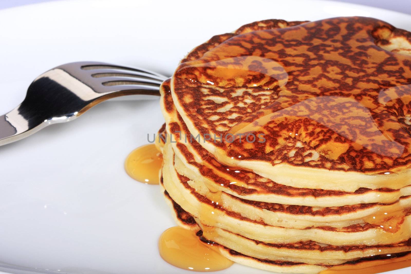 pile of american pancakes with syrup