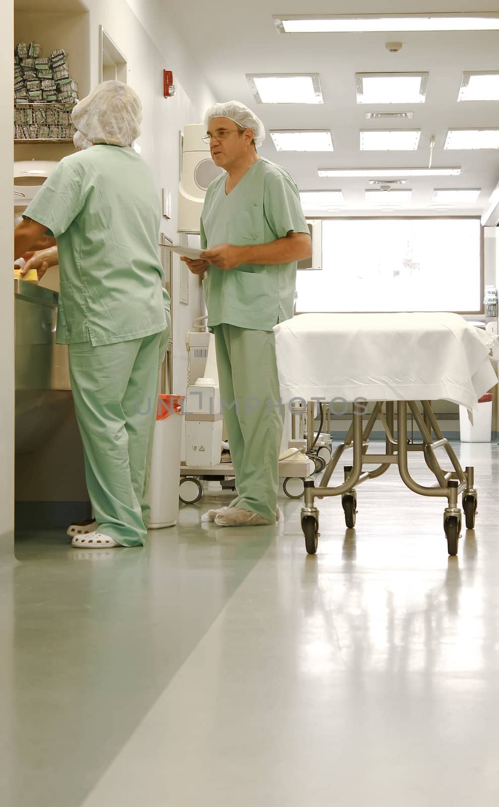 Two nurses talking at hospital by Erdosain