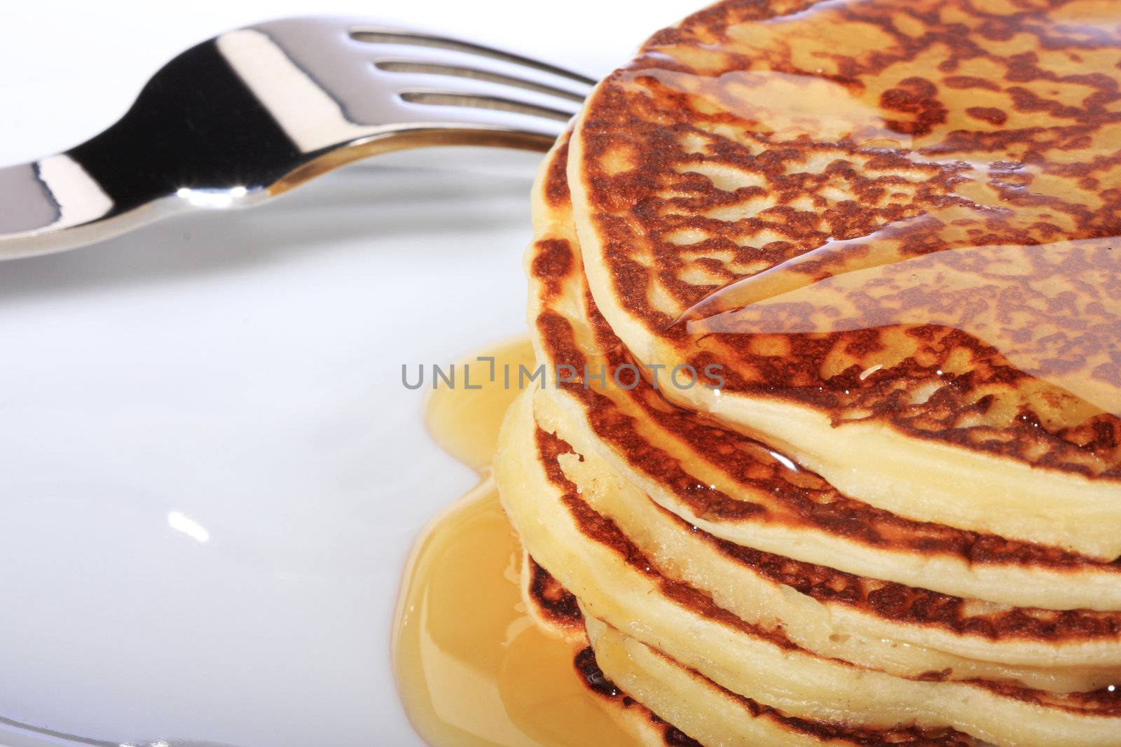 pile of american pancakes with syrup