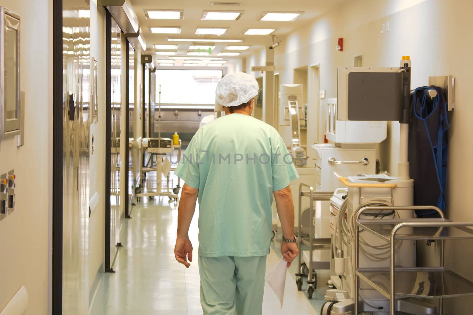 Doctor walking at the hospital corridor by Erdosain