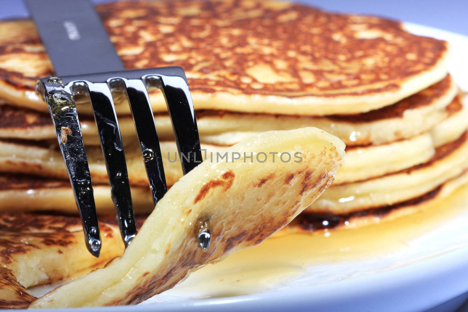 pile of american pancakes with syrup