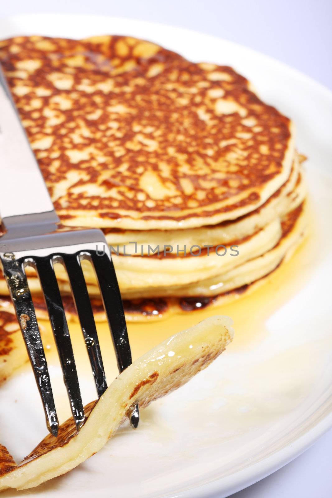 pile of american pancakes with syrup