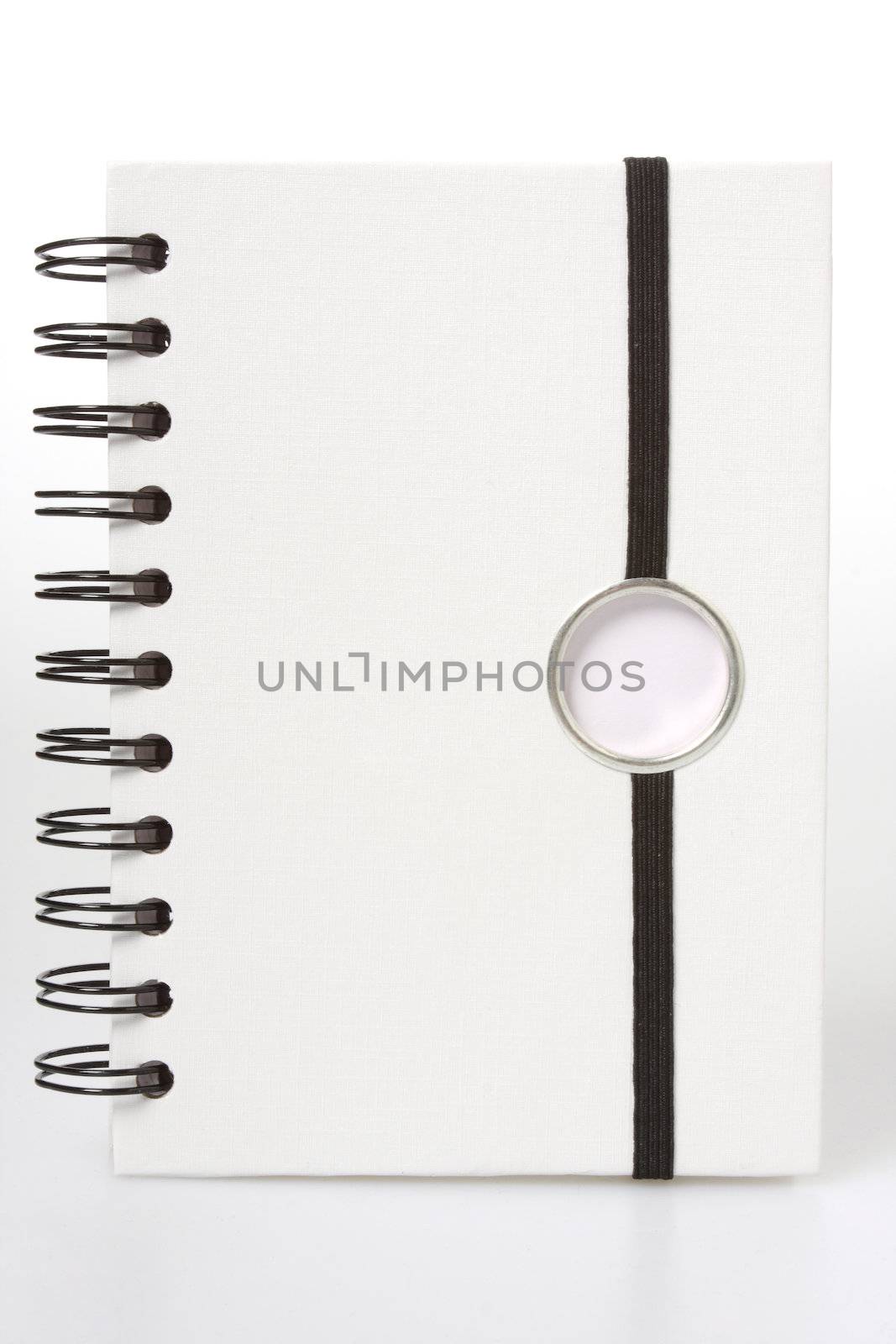 white spiral notebook by sumos