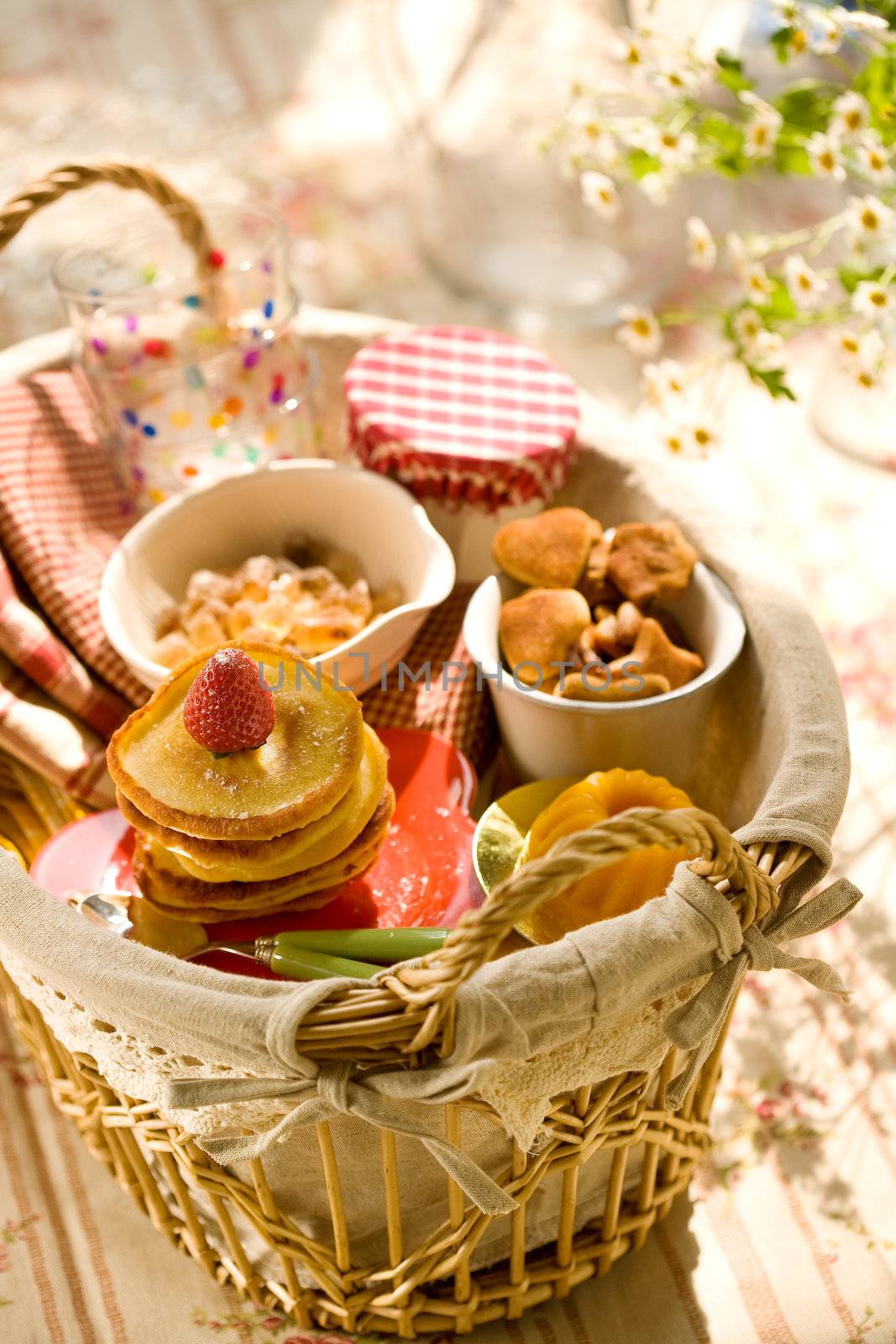 Pancakes and sweets in basket by Gravicapa
