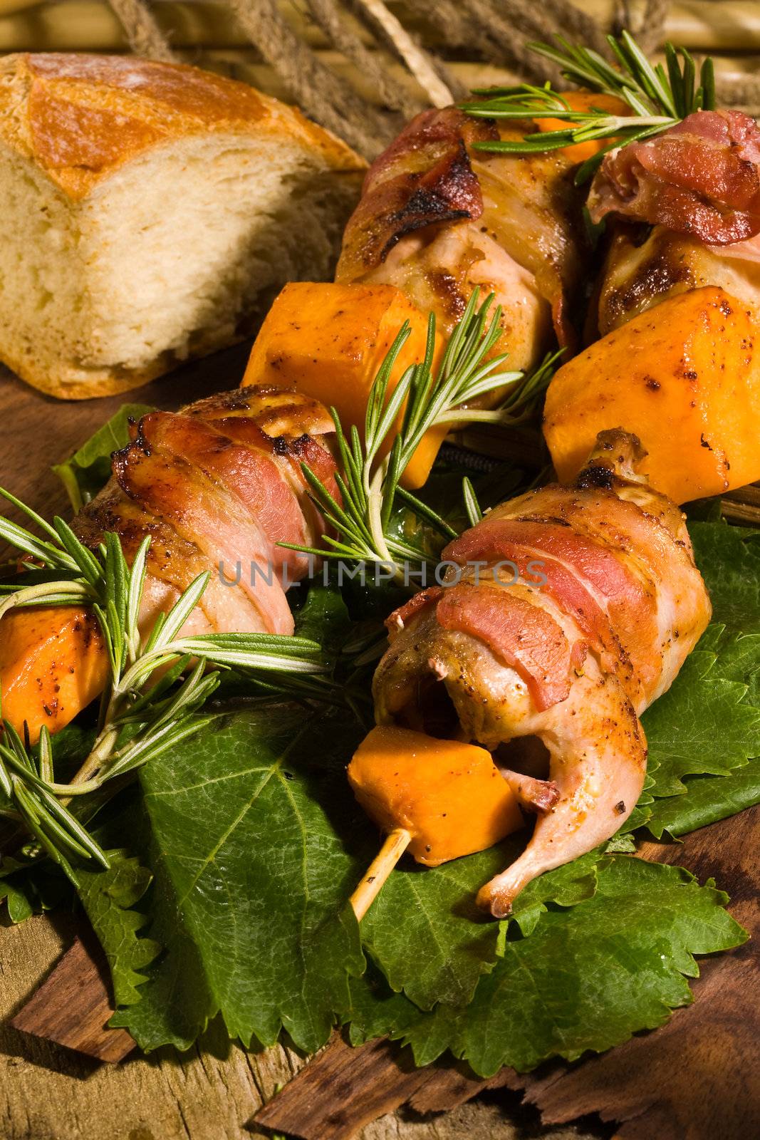 Quail with bacon and pumpkin on skewer