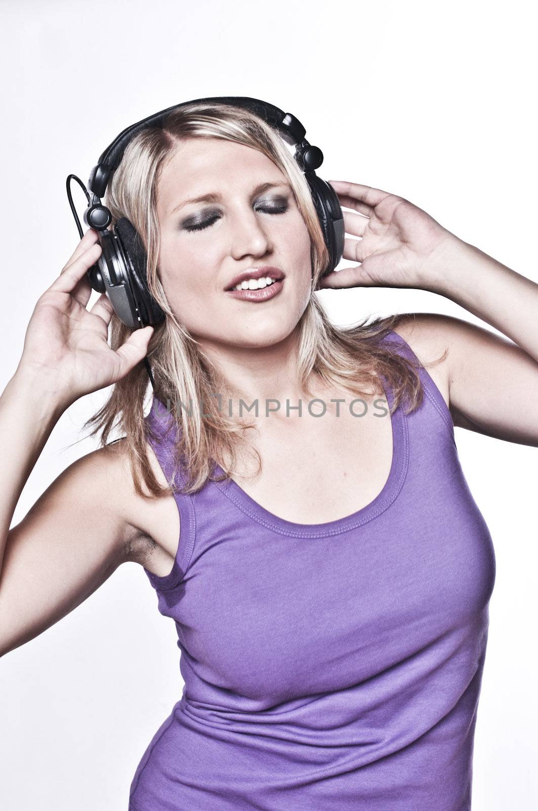 Beautiful Blond Woman Listening On Headphones by nfx702