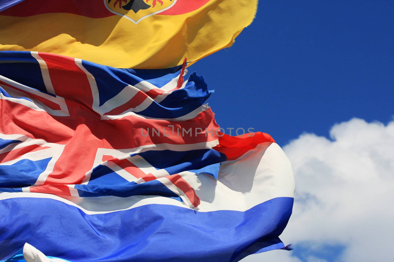 The national flags of France, UK and Germany all flying together agains a blue sky, with copy space, Fantastic as a generic image for anything european or having to do with Europe