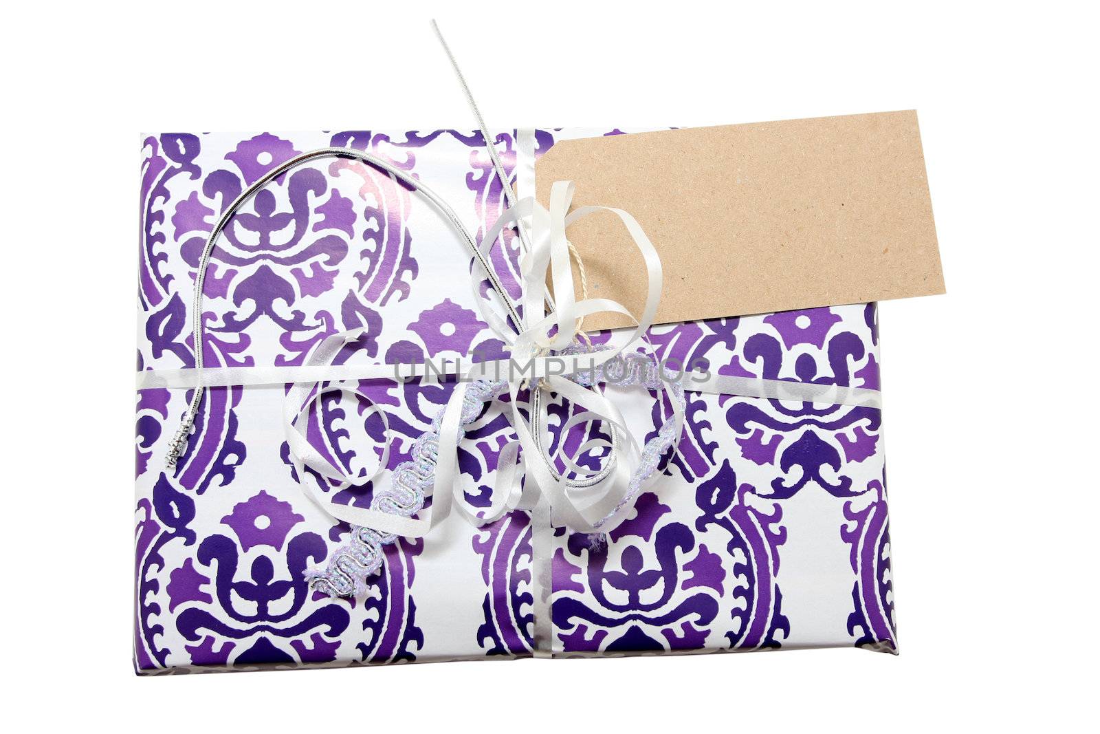 A wrapped gift isolated on white with clipping paths. blank label on right corner of present, Insert your own text. 
