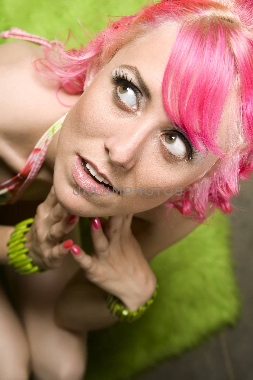 Closeup of Pretty Woman with Pink Hair on Green Rug