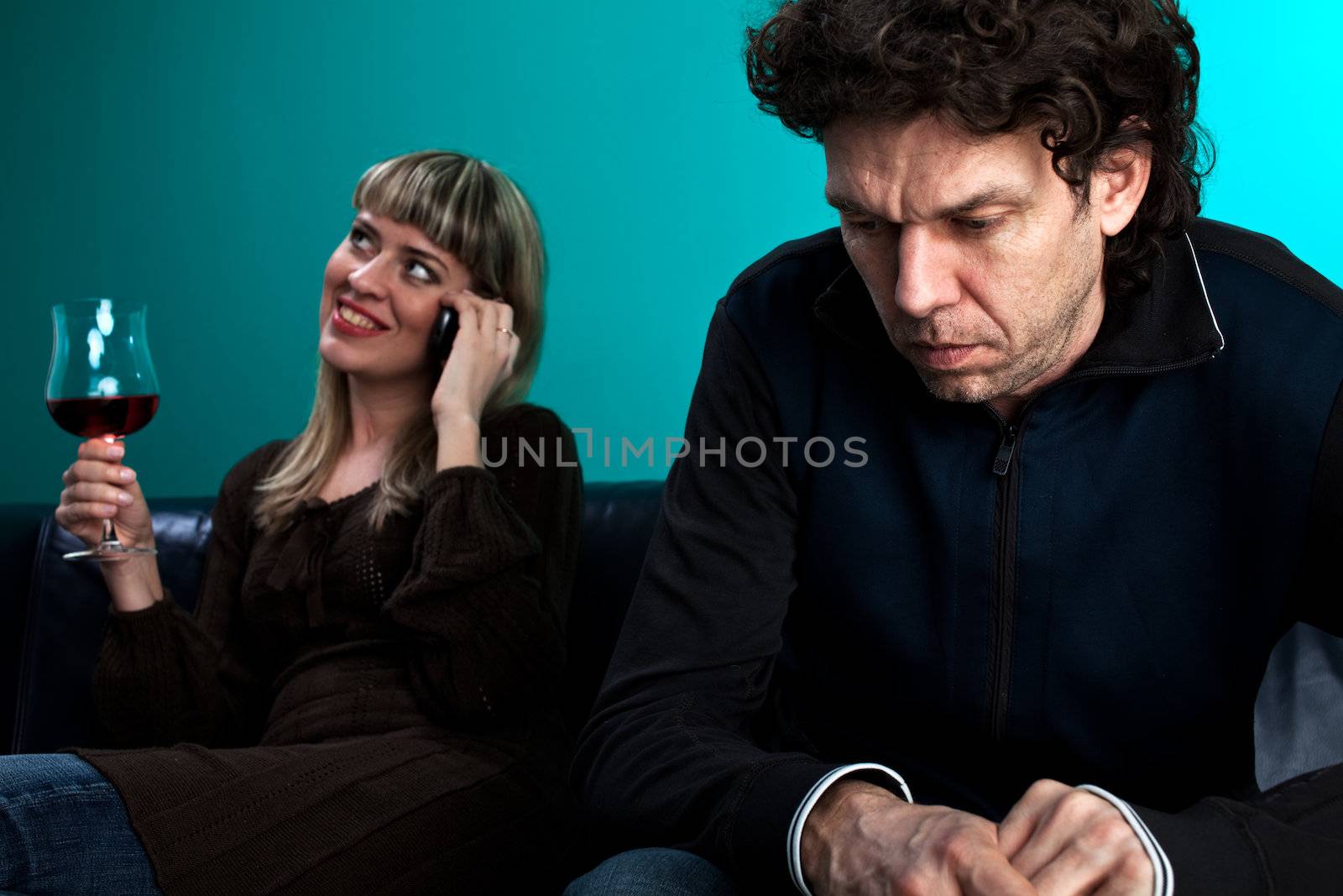woman talking on the phone and a frustrated man