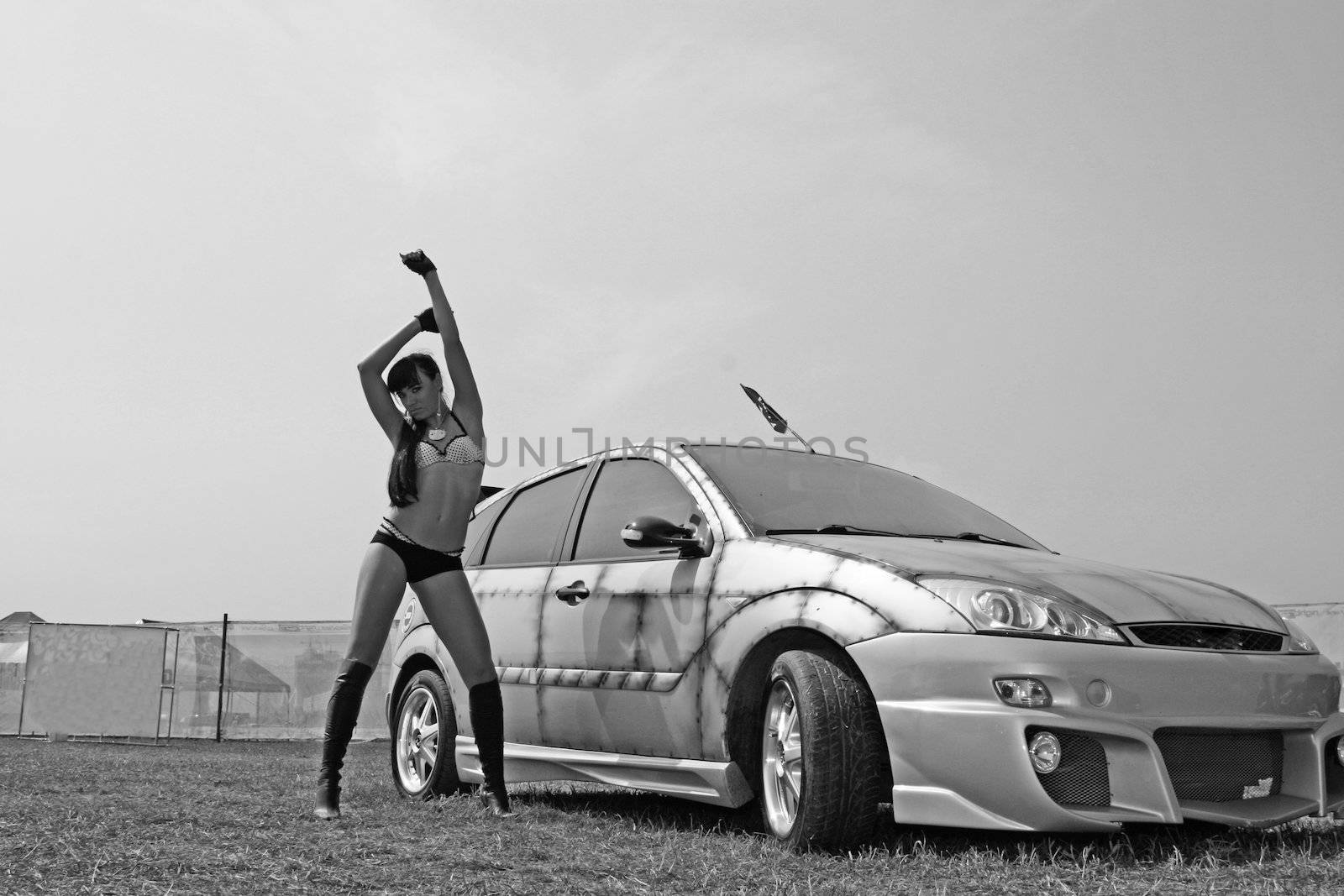 The sexual girl and the sports car in black-and-white