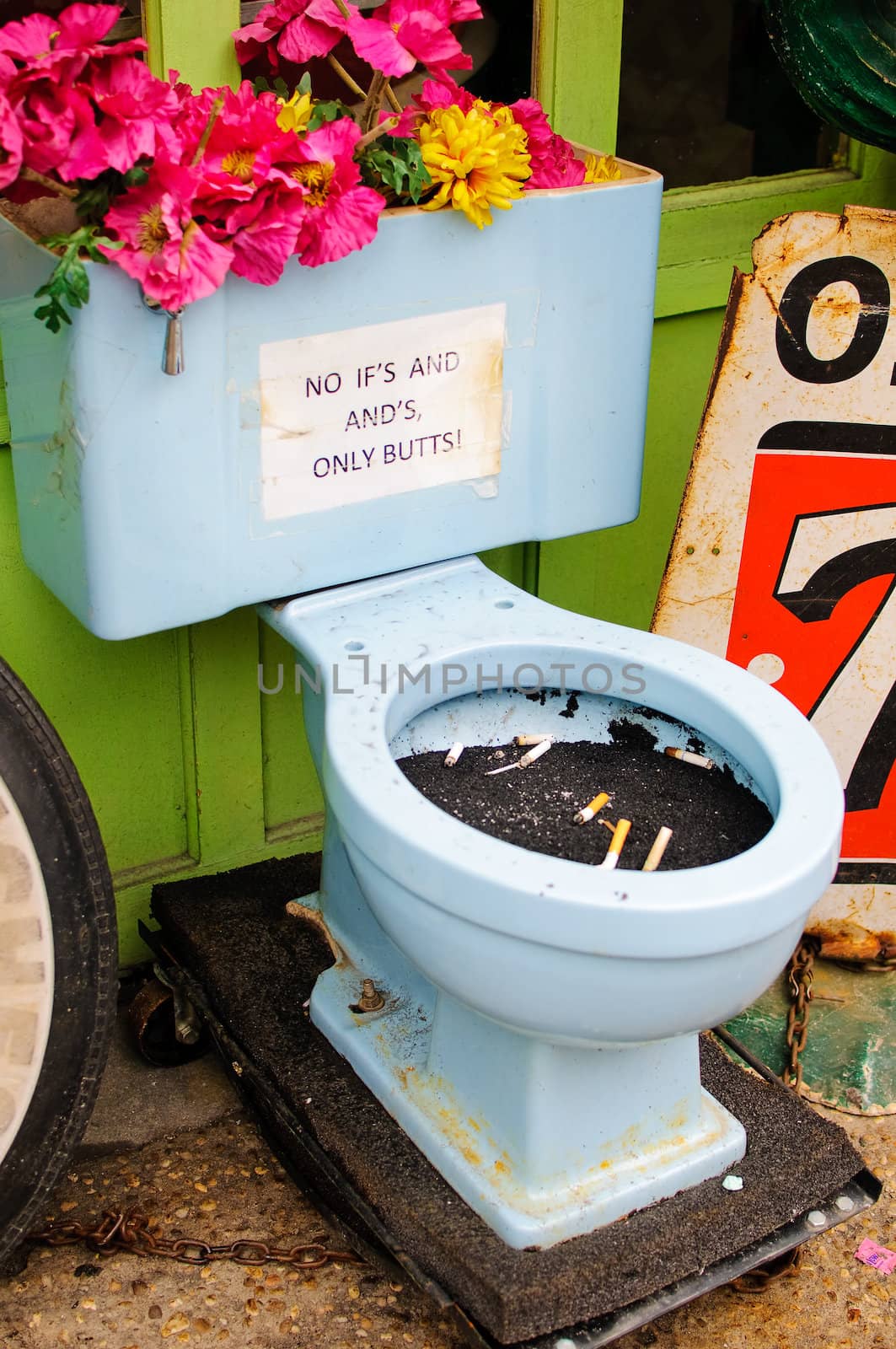 An ash tray toilet bowl with flowers.