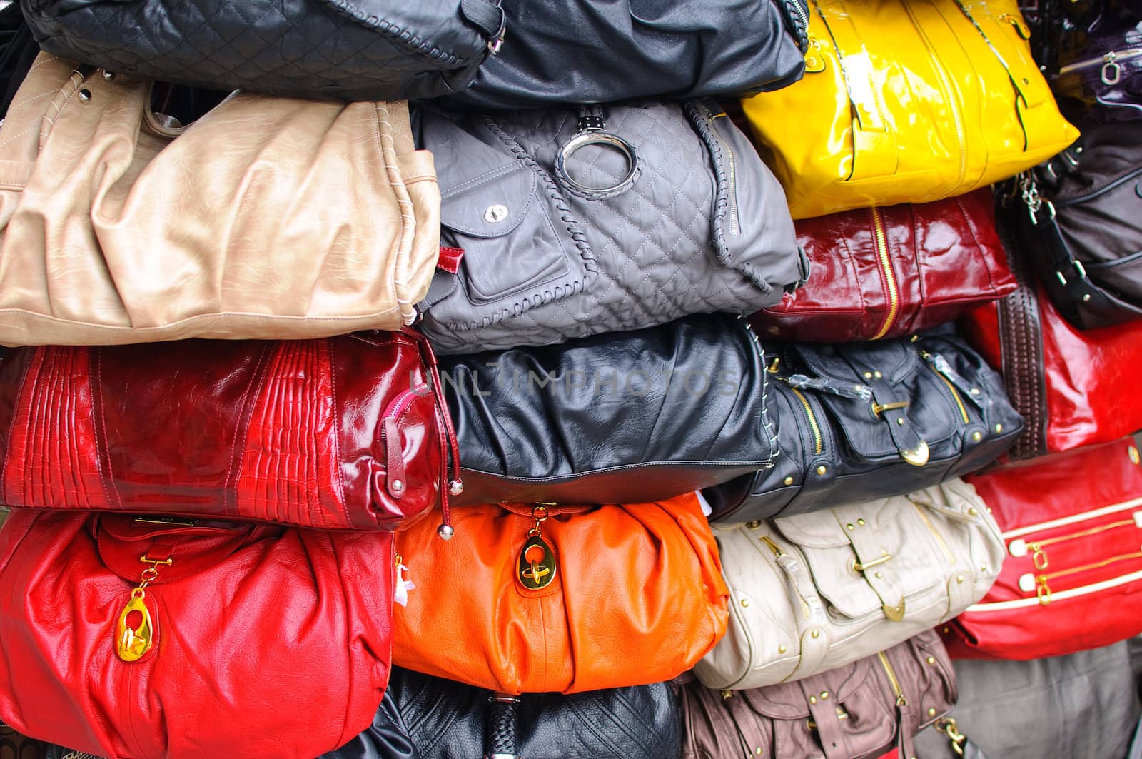 a display of various handbags.