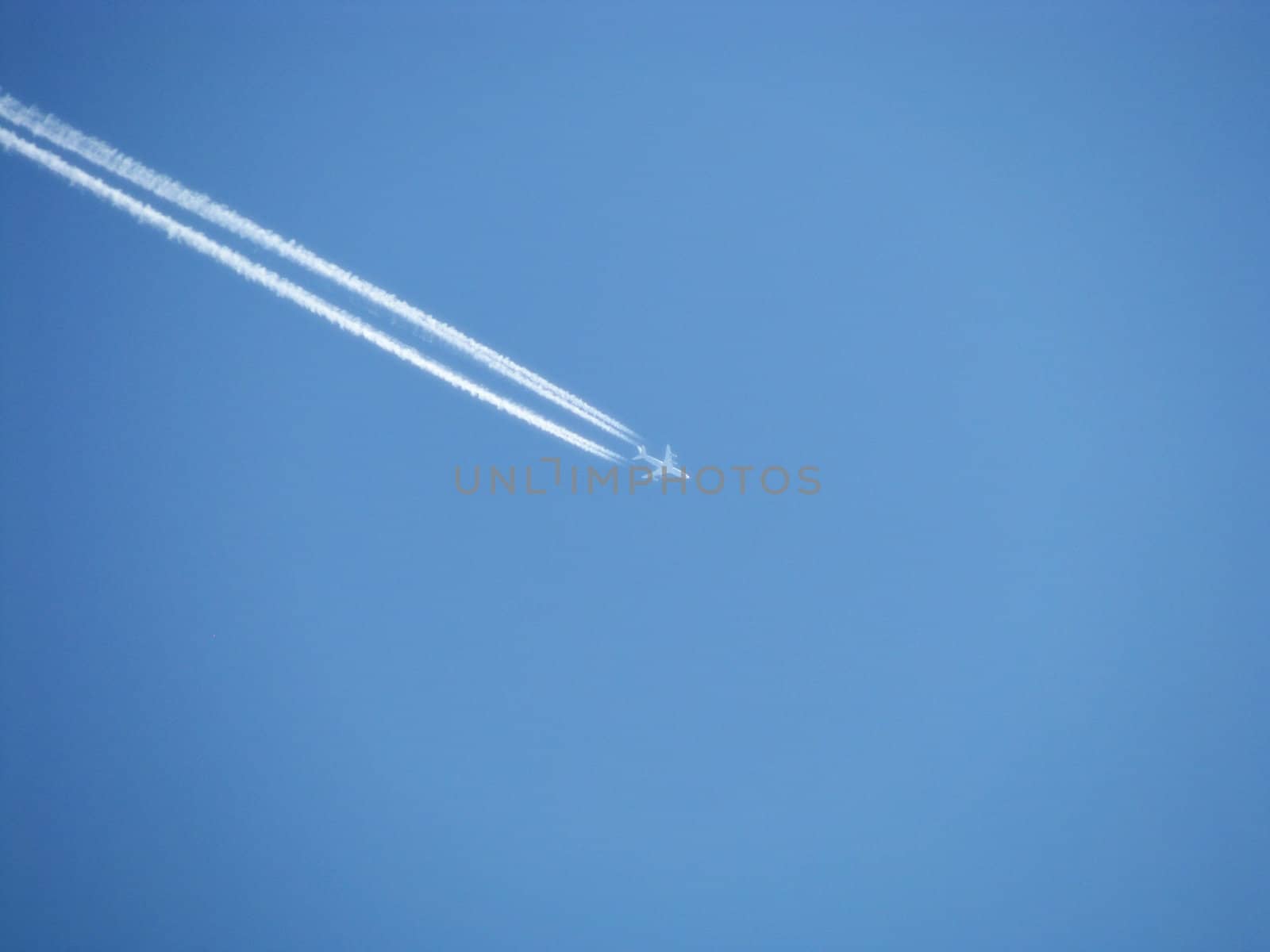 The plane on a background of the blue sky