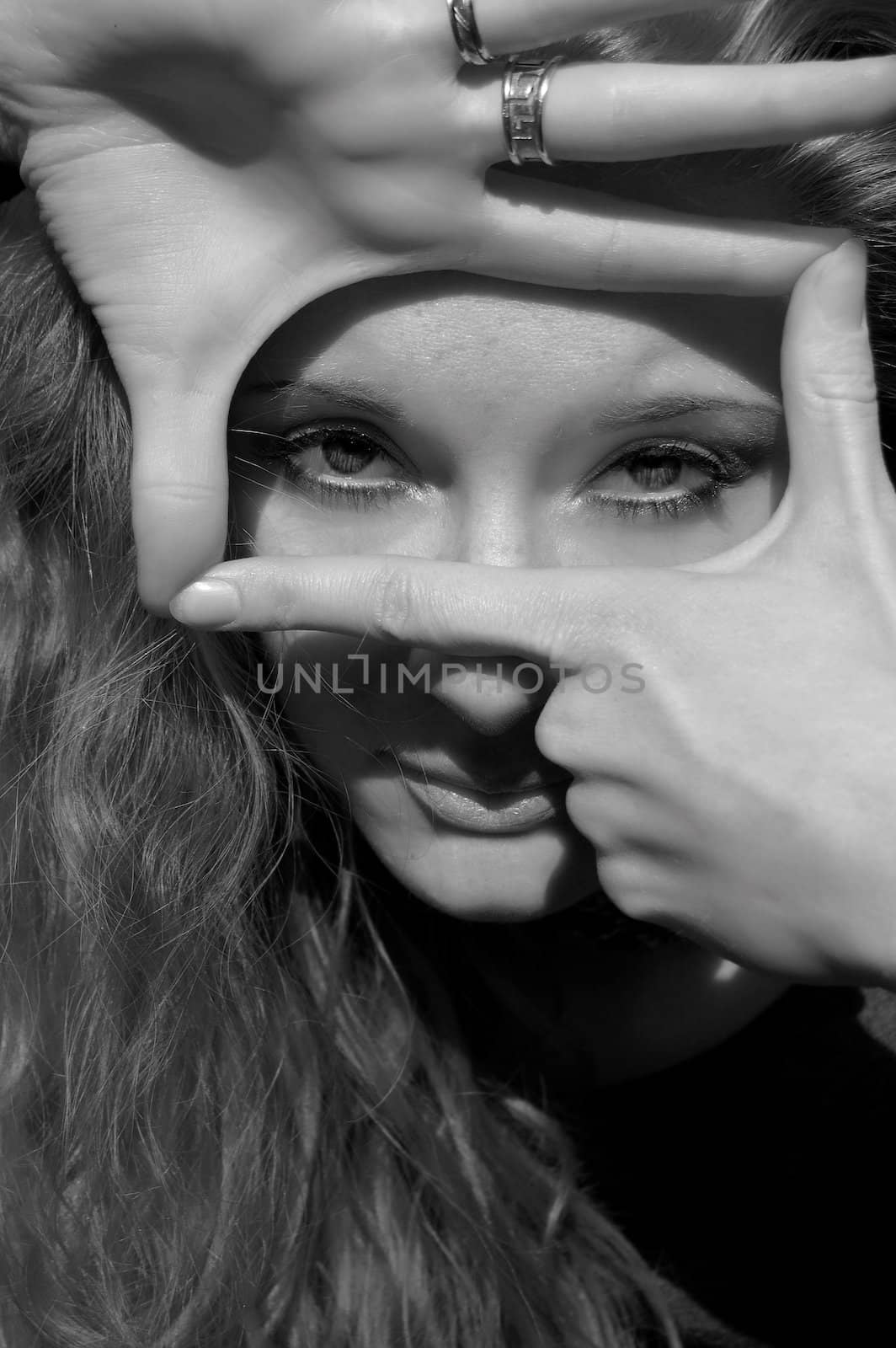 Beautiful girl making signs with hands, black and white image