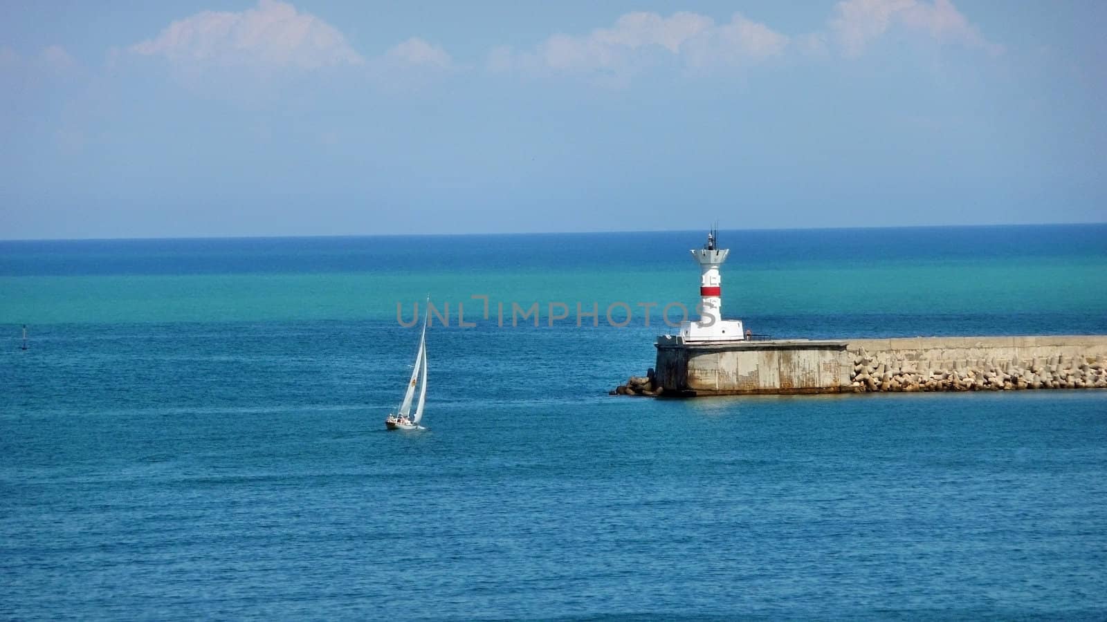 Walking yacht and beacon on an output from the Sevastopol bay 