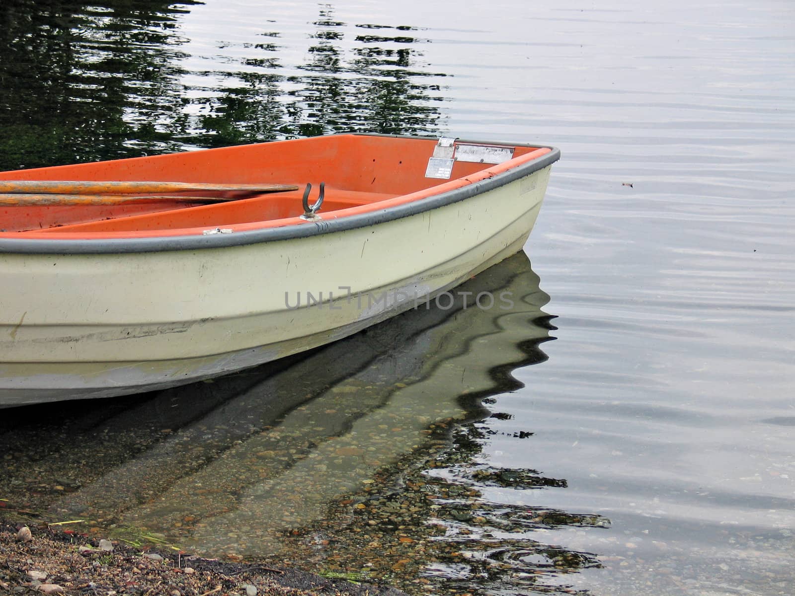Beautiful and colorful reflection of a boat skiff in the water